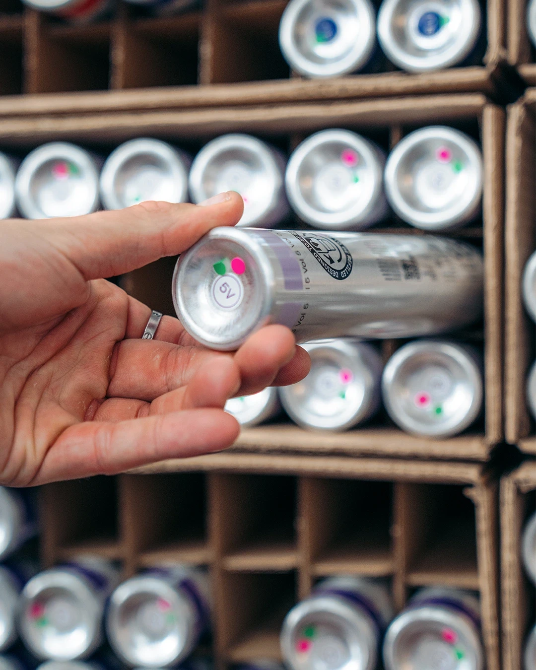 A person removing a yuv® five volume developer cartridge from a box.