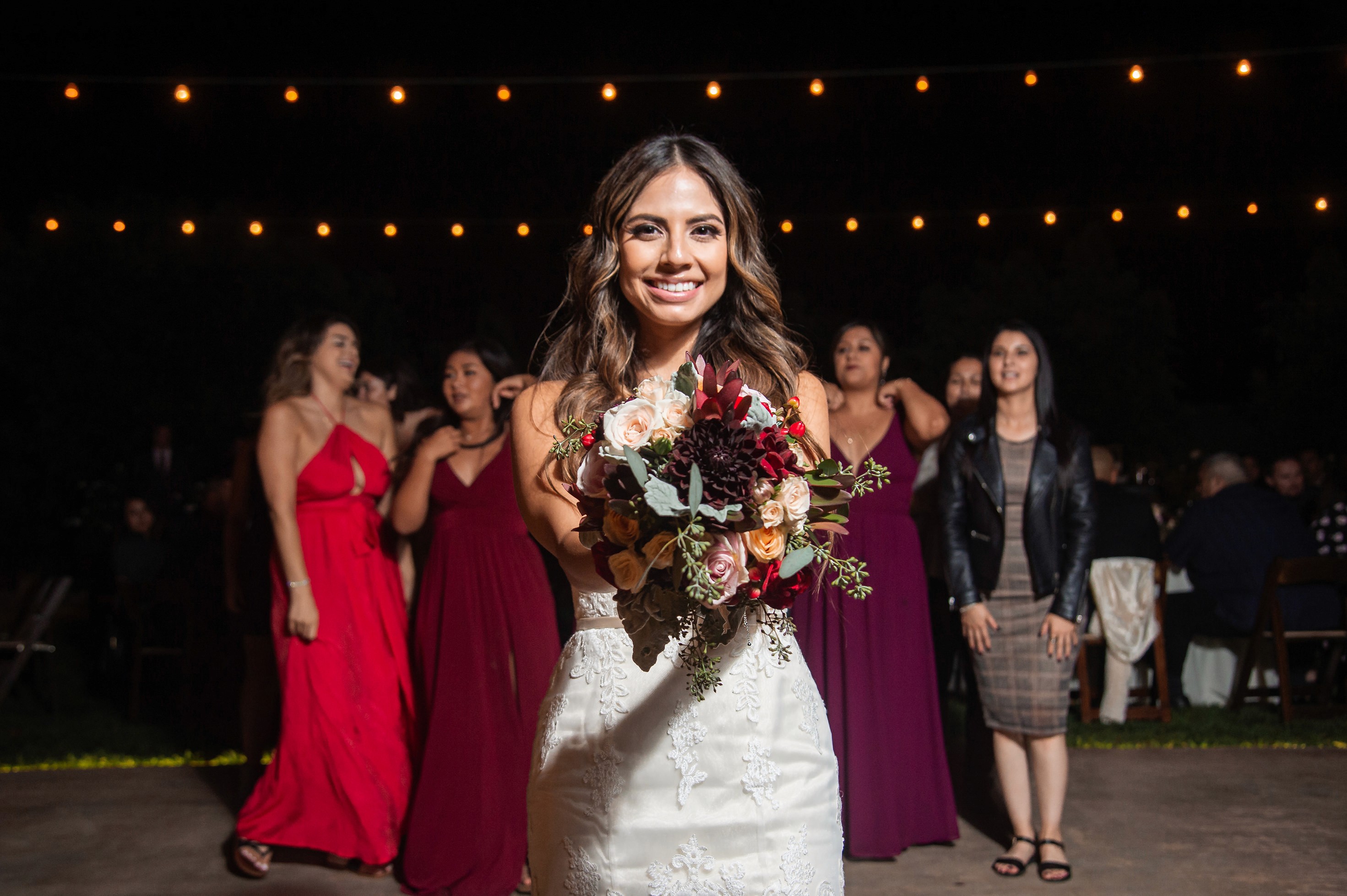 Flat lay wedding details with bouquet, rings, and sparkling bridal heels