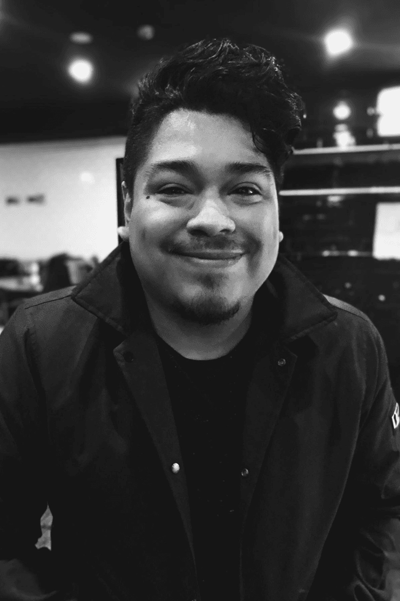 Portrait of Joshua Fabian, Senior Industrial Designer, smiling in dark jacket