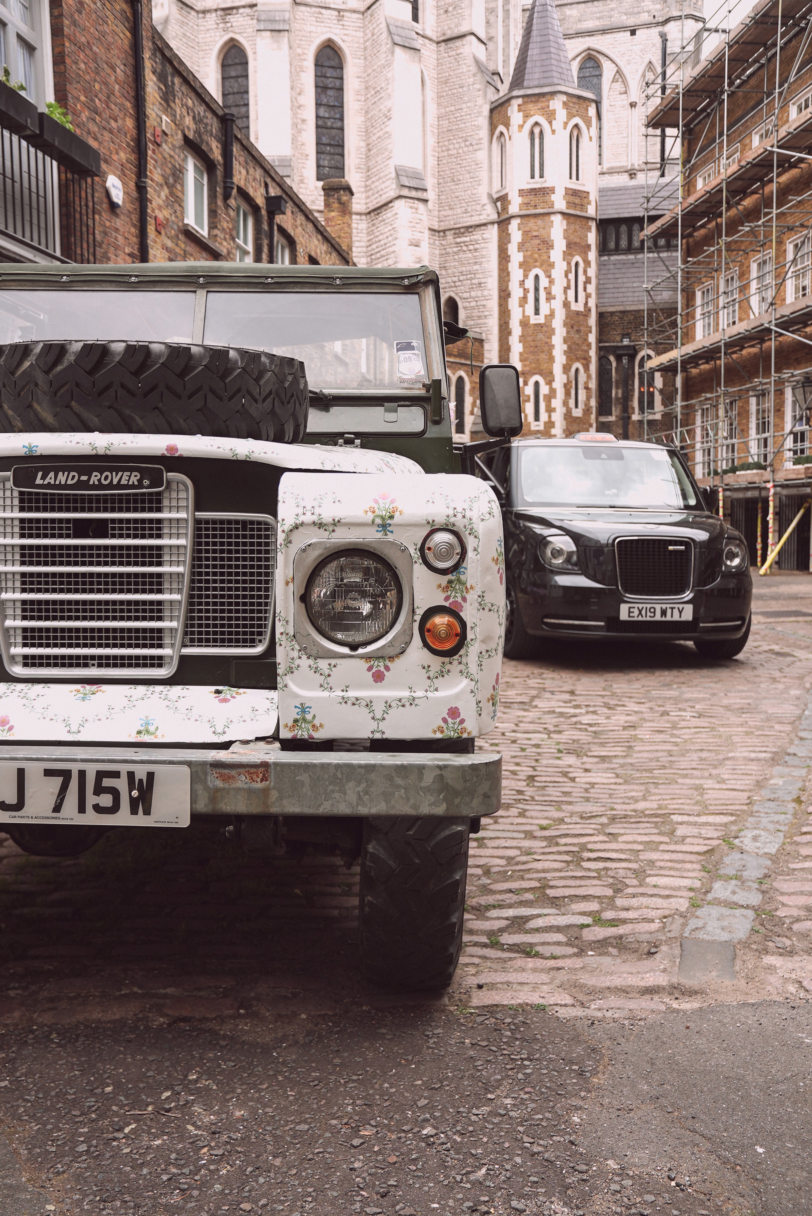 Bride in white dress walking on street, man in background