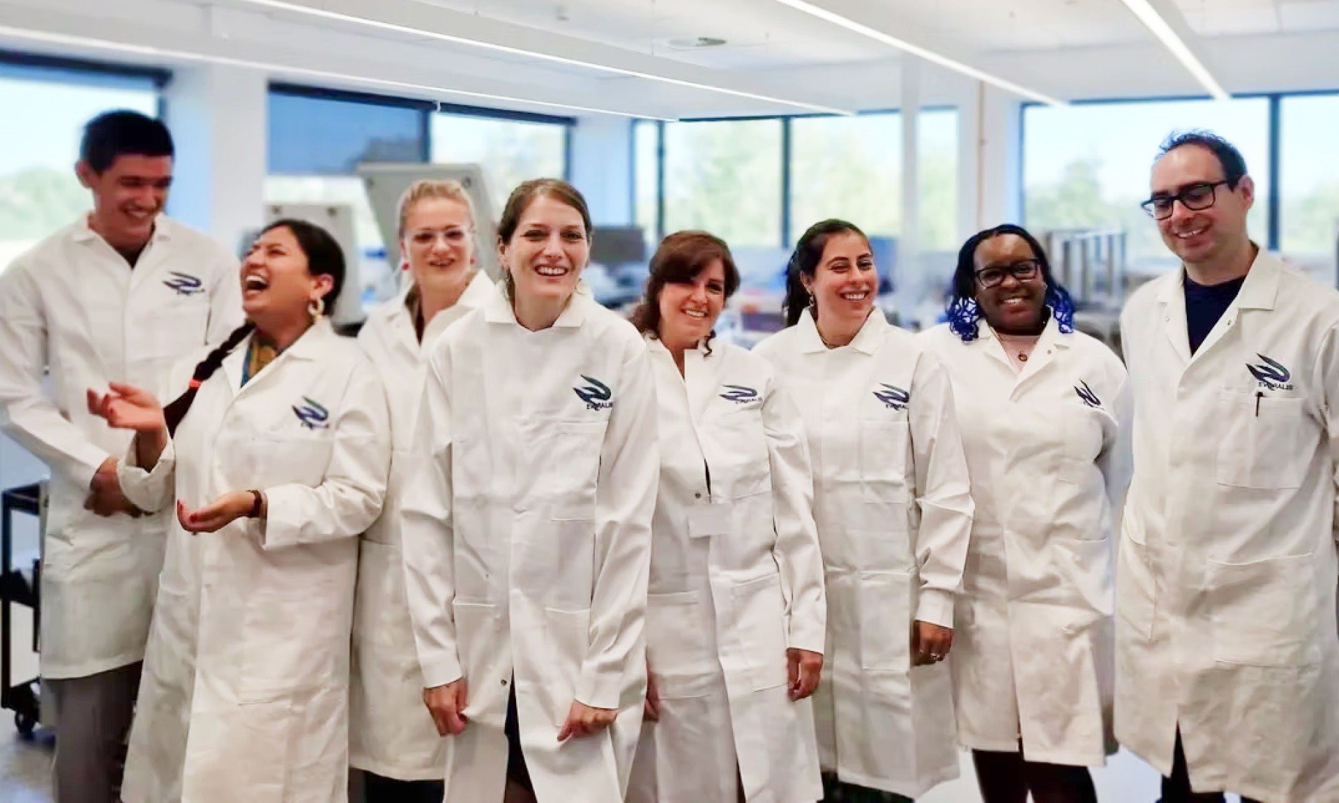 A photo of Evoralis lab technicians standing in a line and smiling
