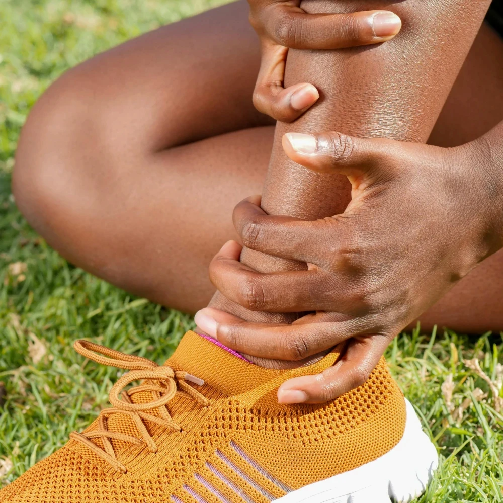 A woman holding her knee in pain