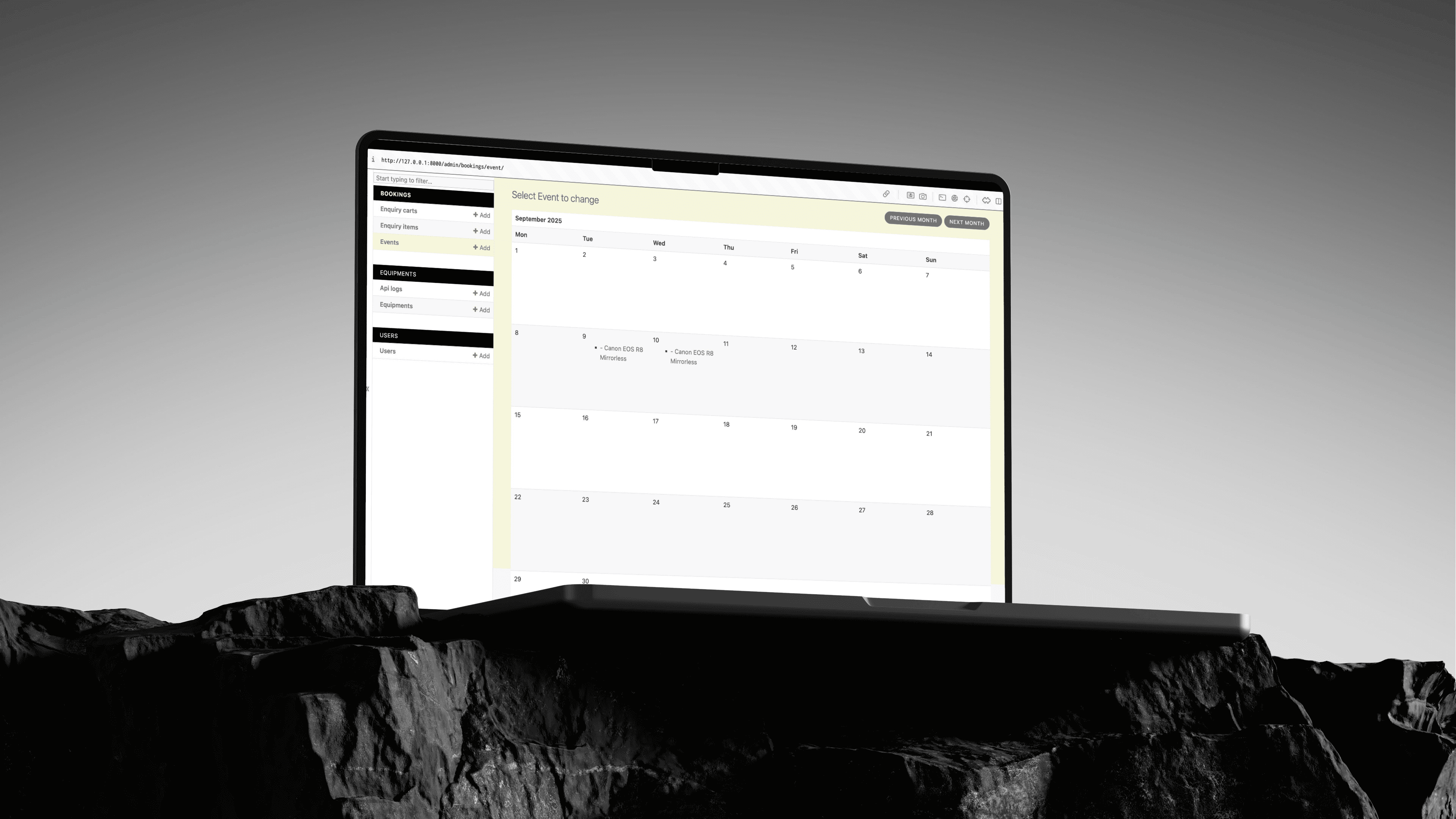 Laptop at an angle on a rock with a booking calender on the screen
