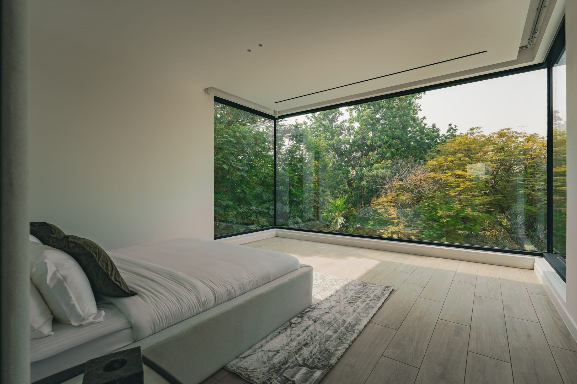Image of a bedroom and a big glass window 