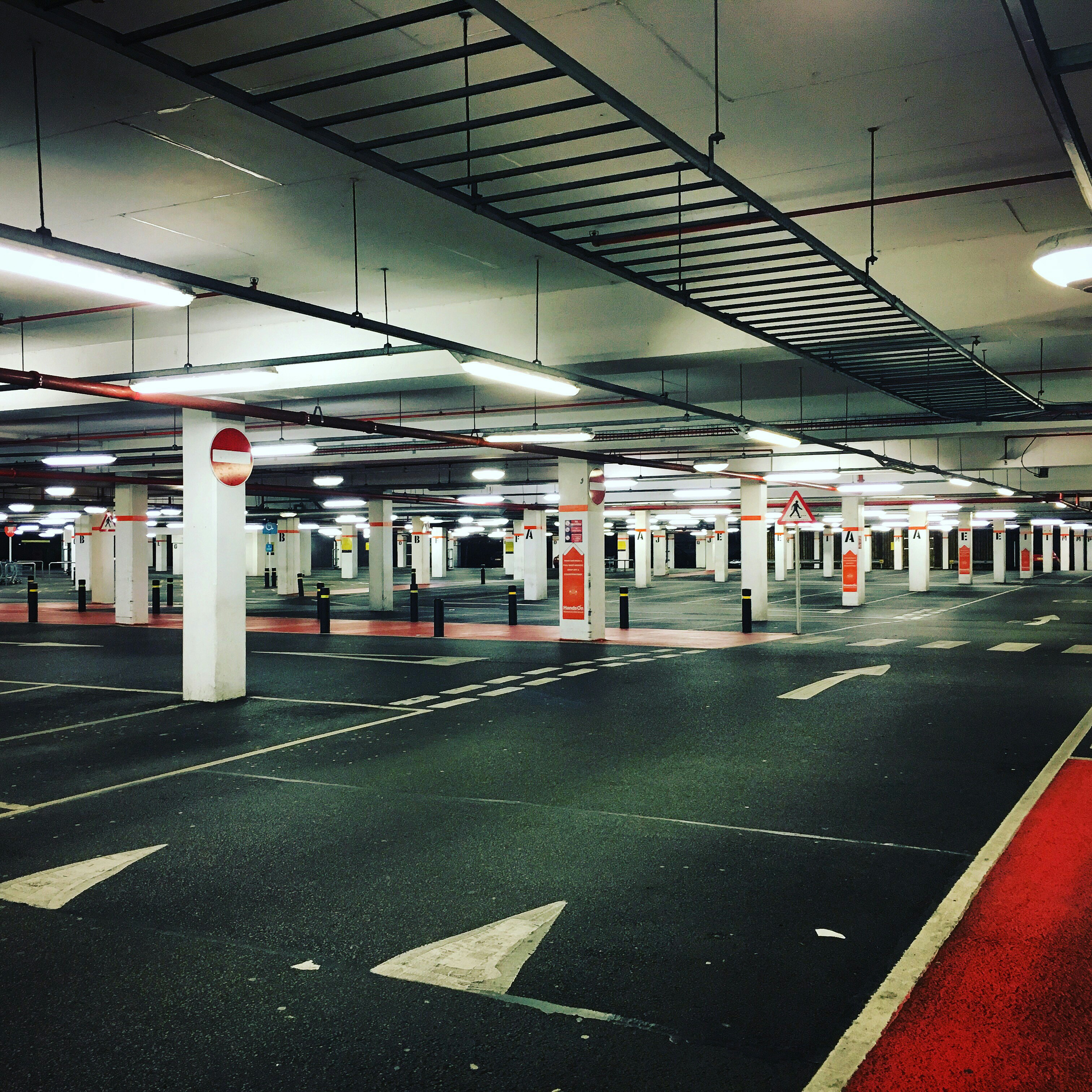 An indoor parking lot with clearly marked spaces, representing Kowee’s expertise in optimizing car park dynamic pricing.