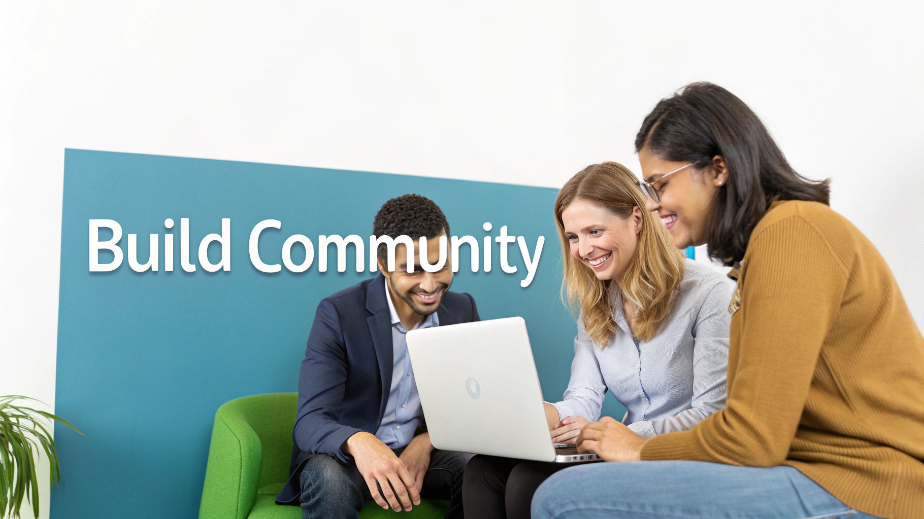 Three diverse professionals collaborating on laptop in modern office with Build Community wall sign