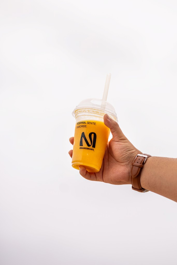 A man stading with Surfboard