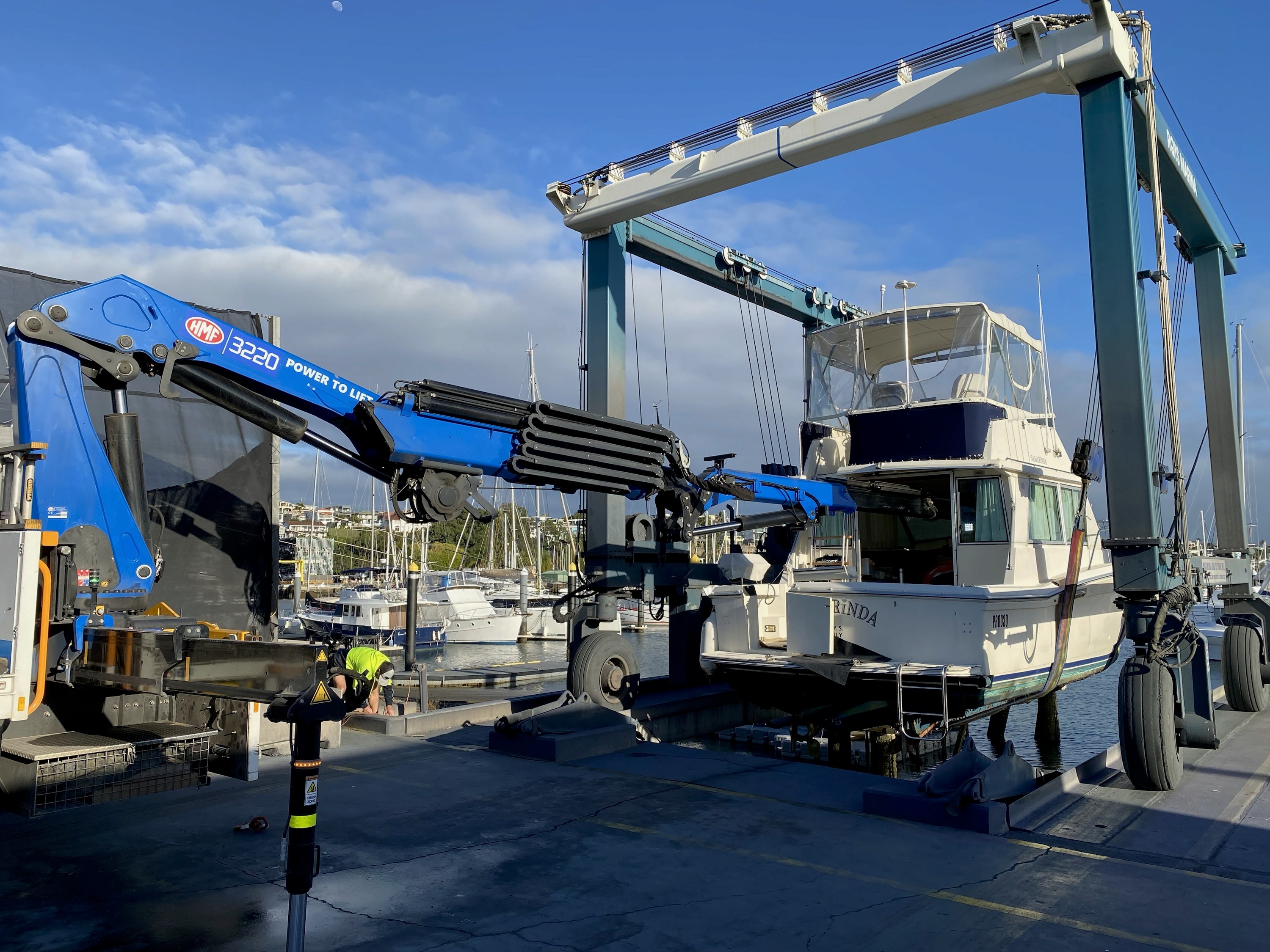 Crane truck reaching into a boat