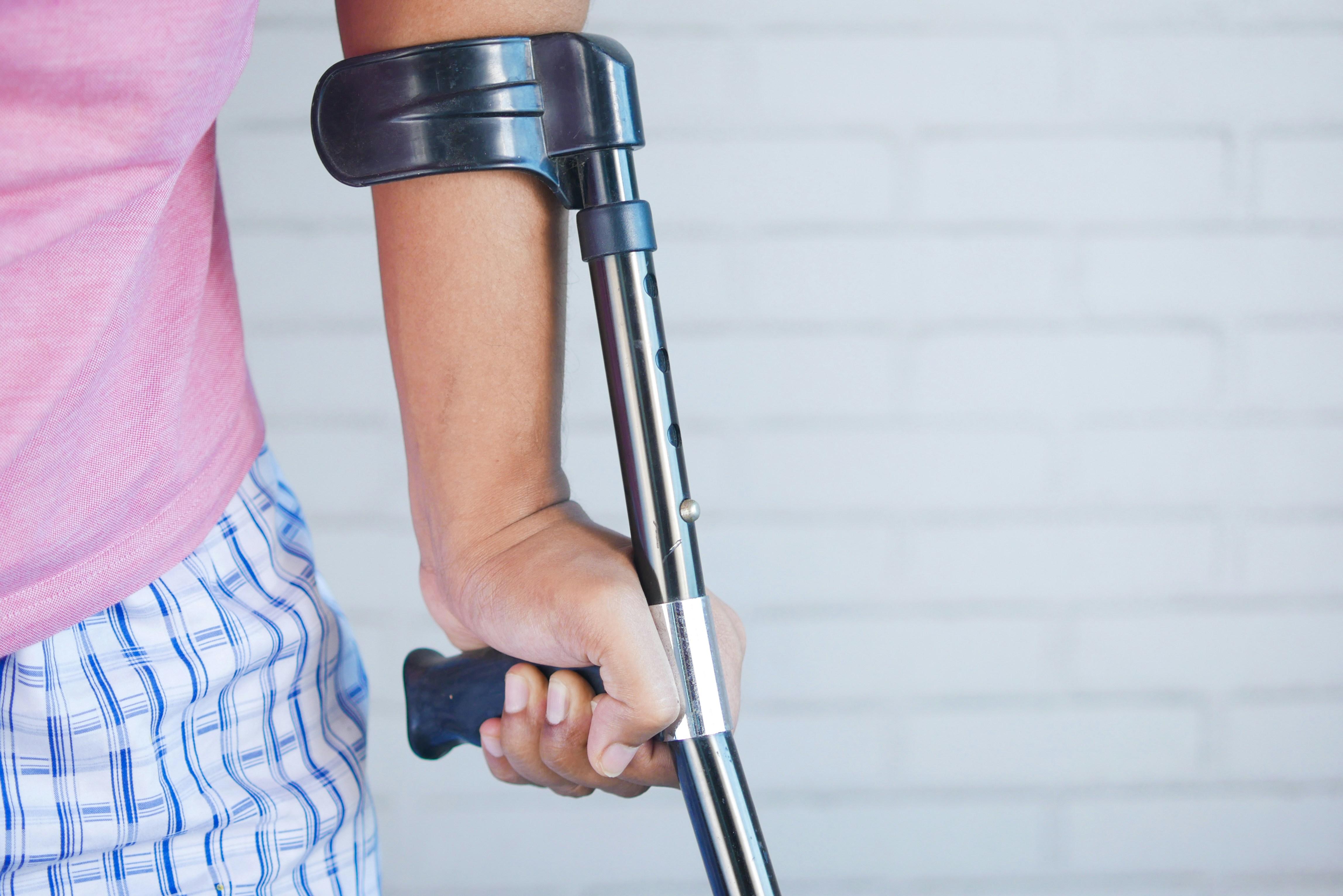 Injured person using a walking stick for support after an accident in Ontario