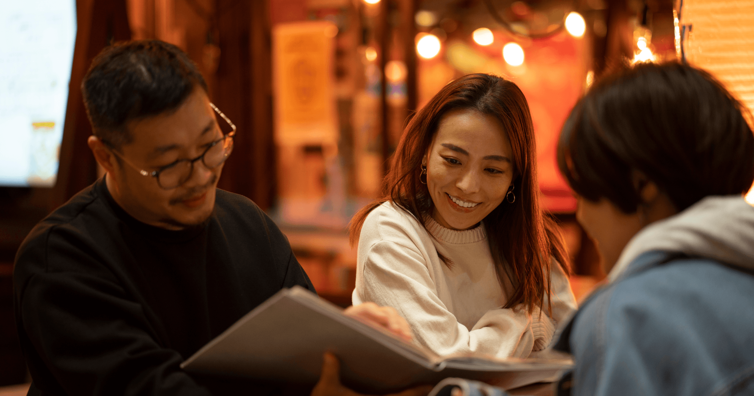 Customers looking the menu and smiling