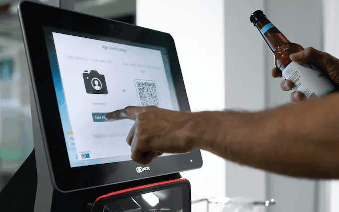 “Customer using a fingerprint-activated card to complete an age-restricted purchase.