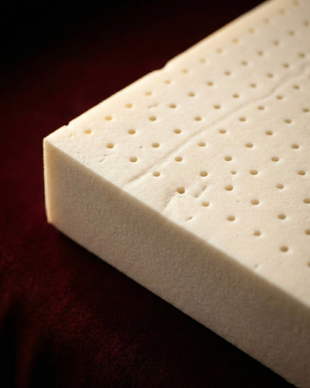 Terracotta wall interior with wooden architectural elements and dramatic natural light.