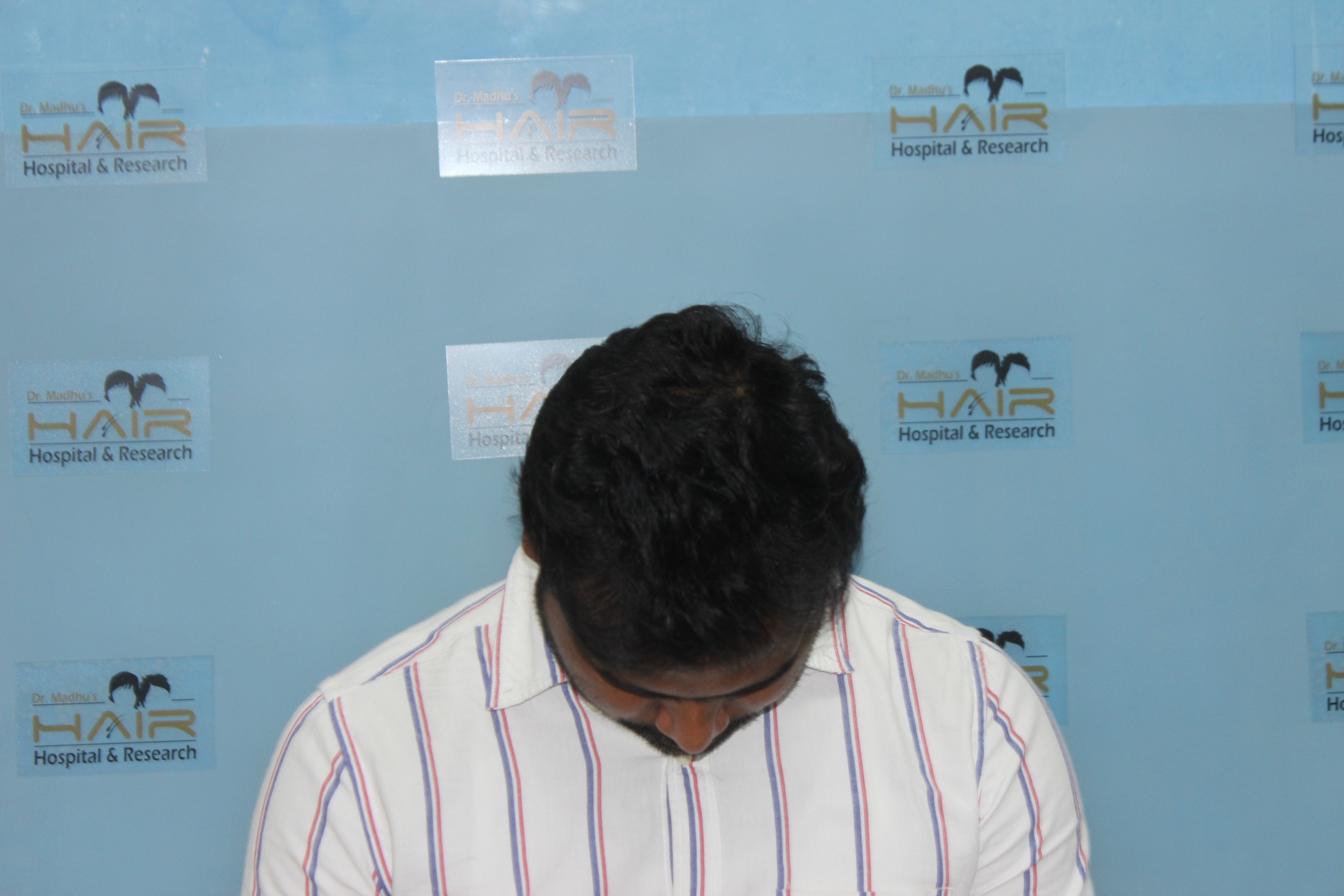 girl wearing black vest raising two hands near green grass field during daytime