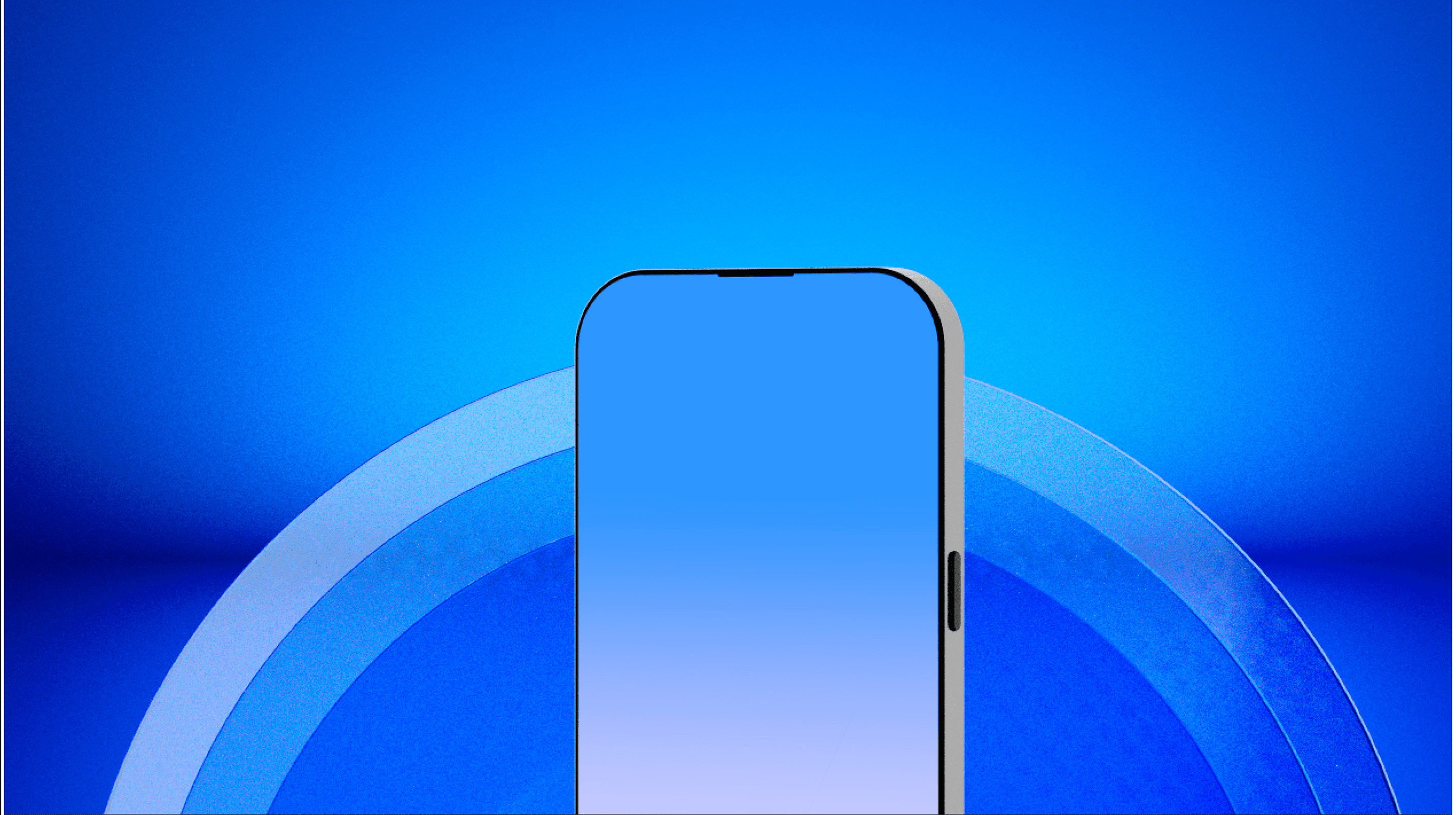 two women sitting at a table looking at a cell phone