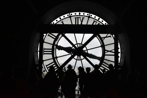 A silhouette of people viewing a clock., illustrating the DELF and TFC result validity period