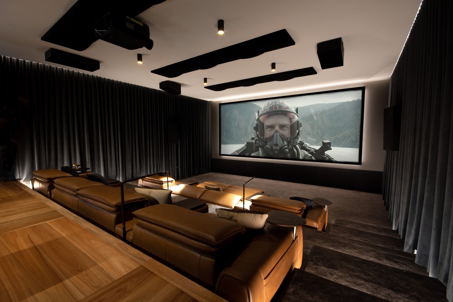 Home theater with leather seating and movie playing
