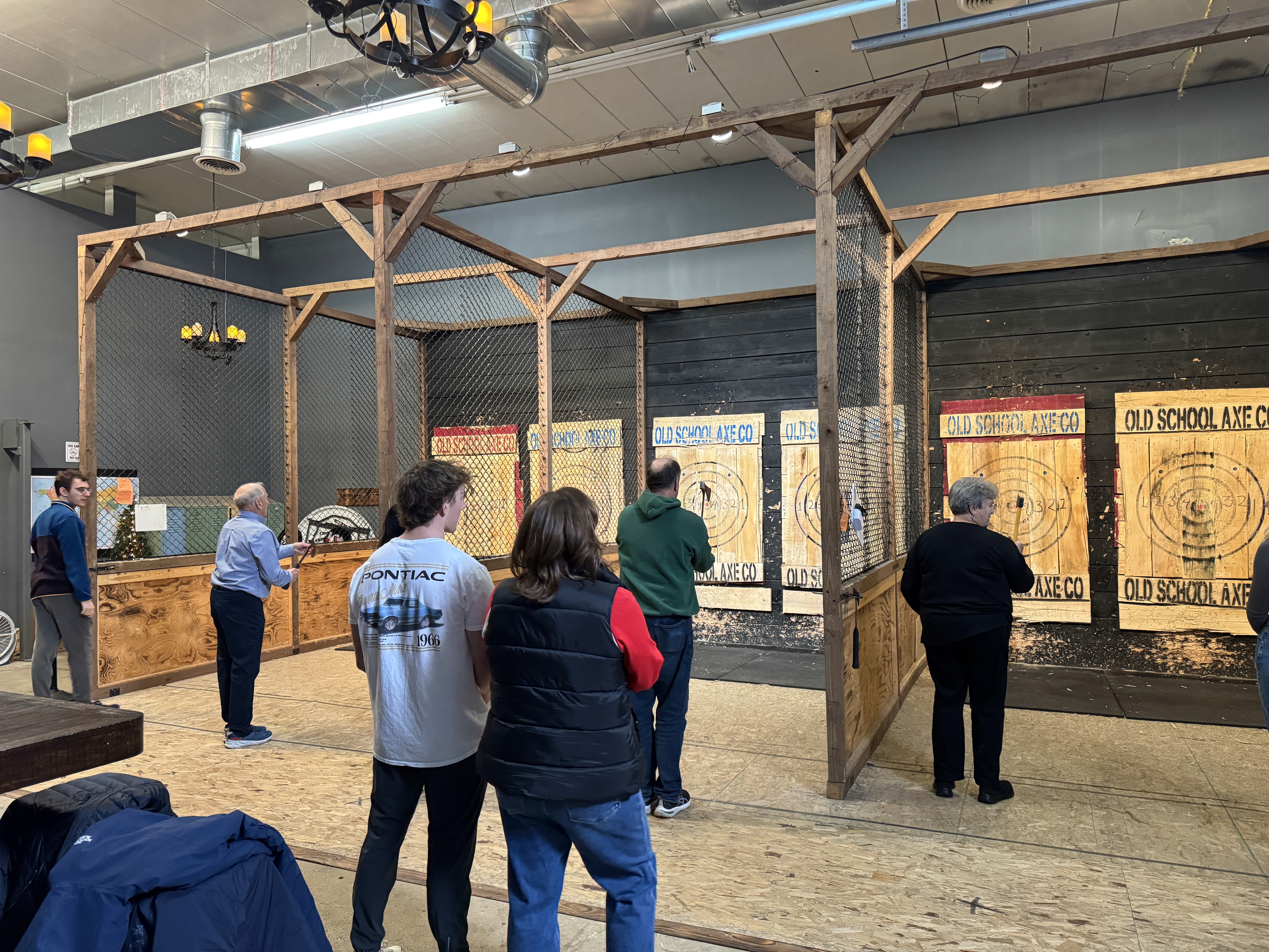 A group of people throwing axes at Old School Arcade