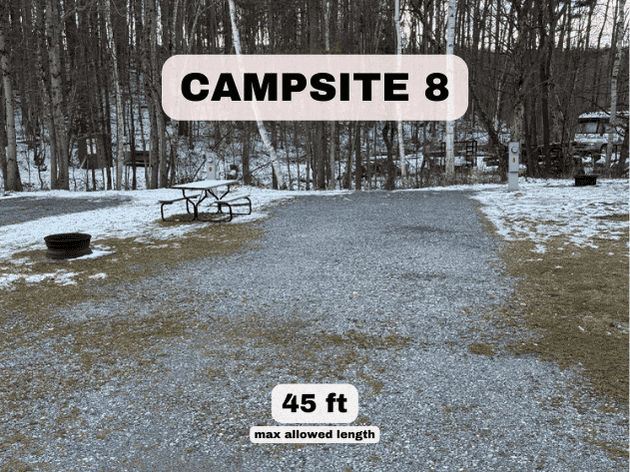 Campsite 8 at Pine Hollow Campground, a 45ft gravel RV site with dual pedestals, fire ring, and picnic table