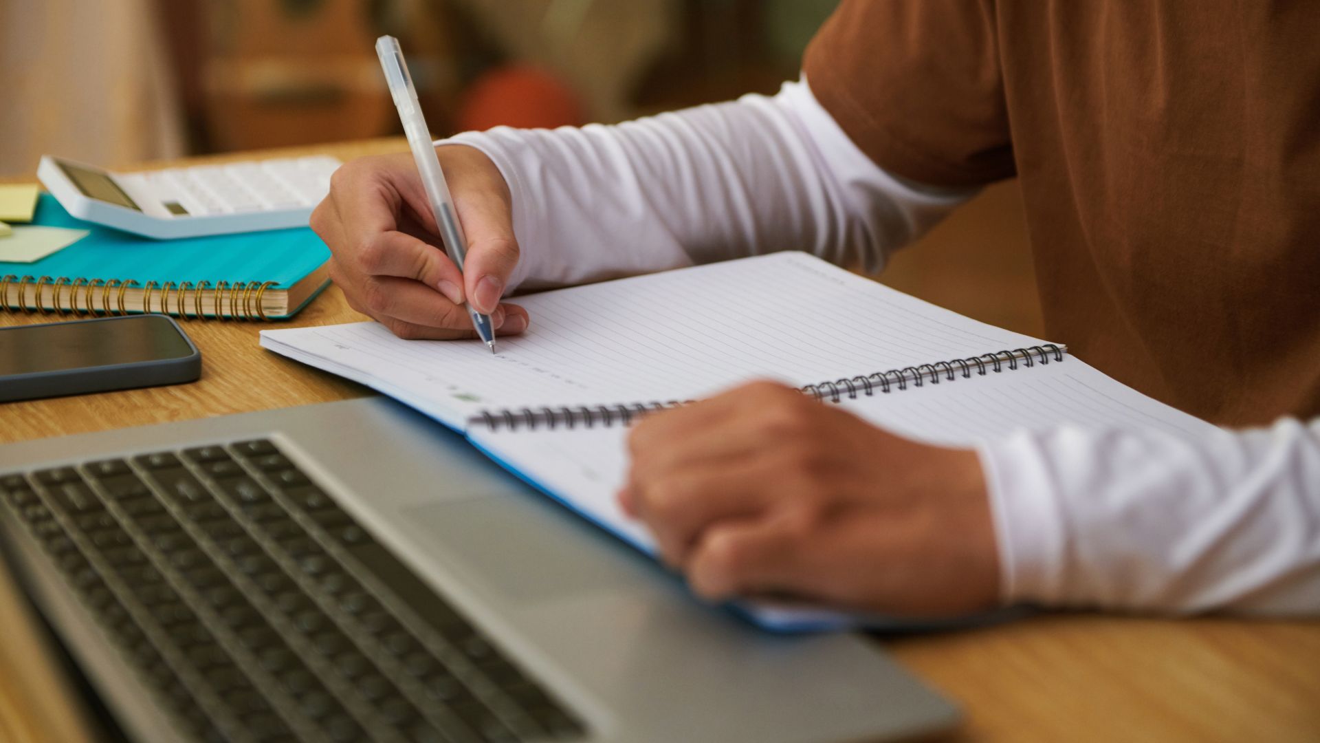 person sitting on grass and using phone