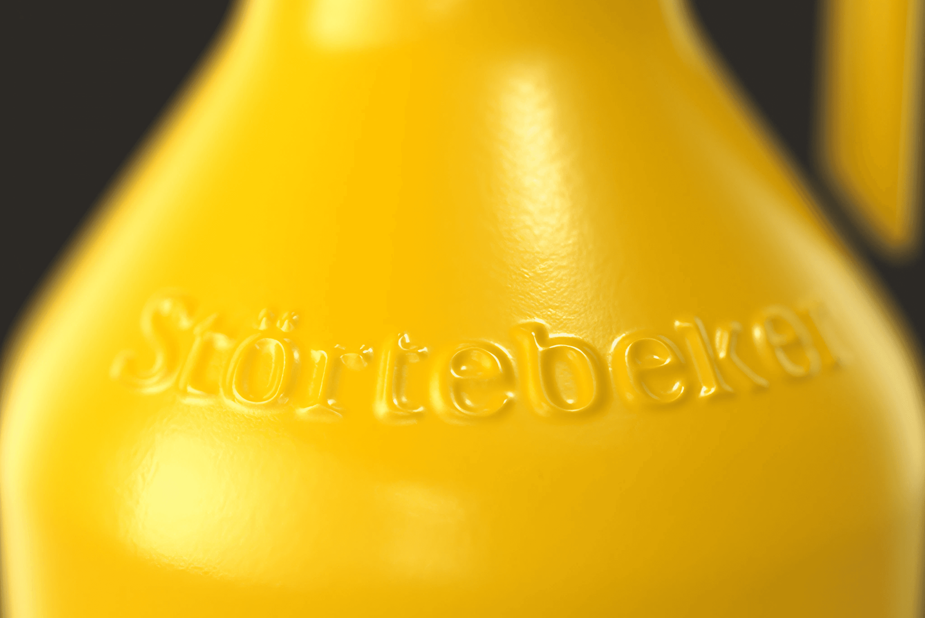 Störtebeker logo embossed on yellow surface.
