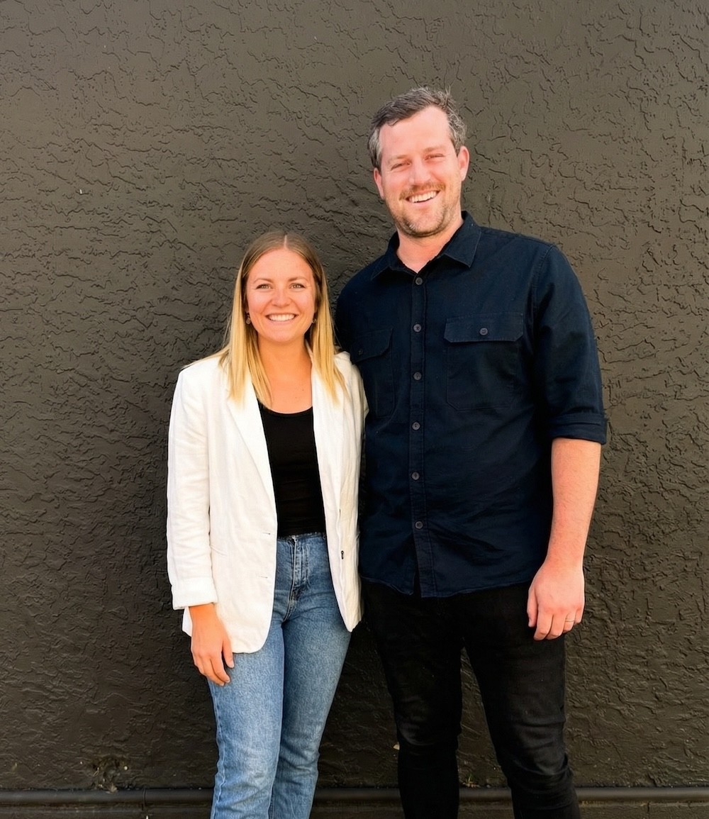 a man and a woman standing in a field