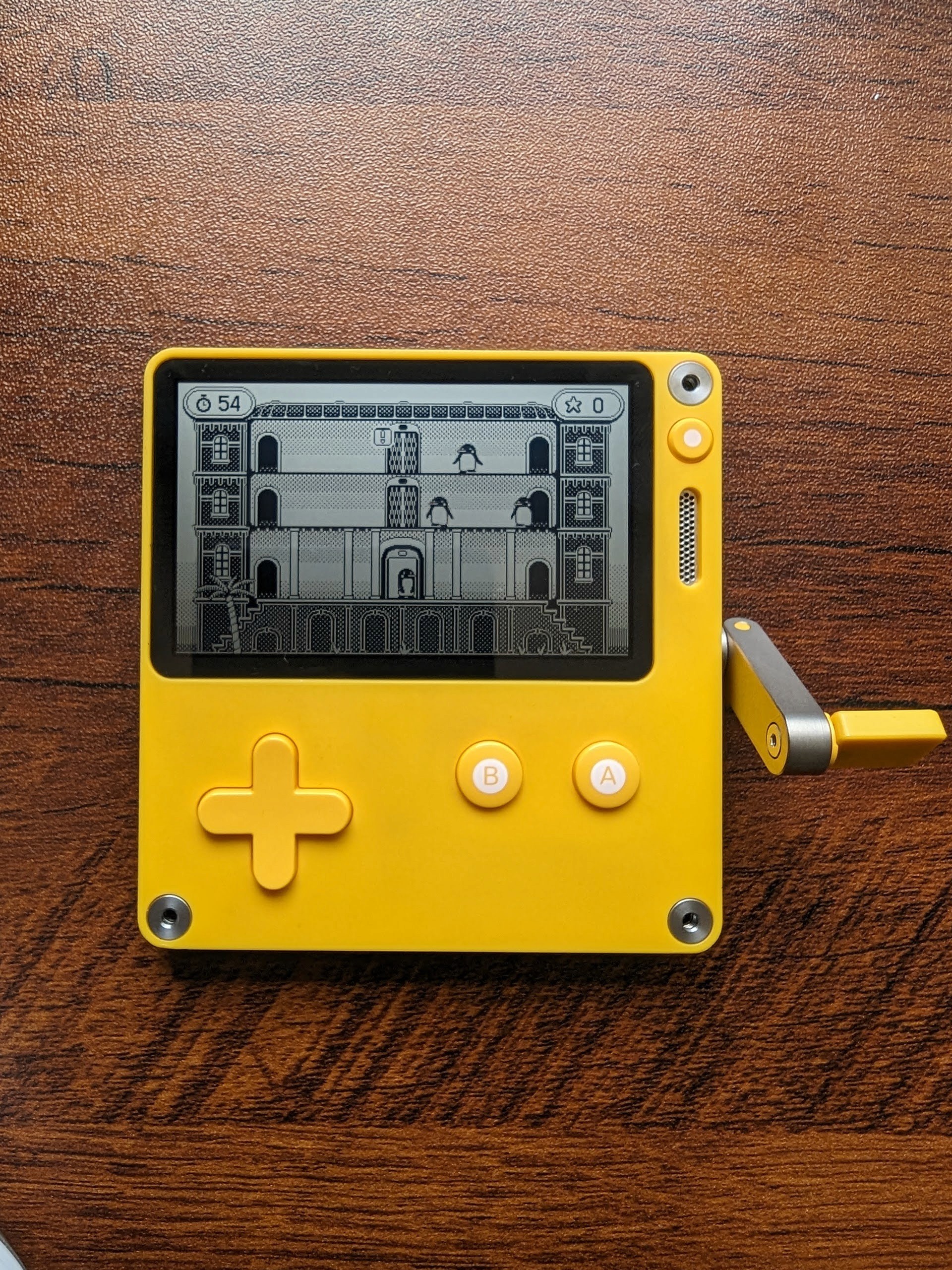 an image of a bright yellow handheld square video game console