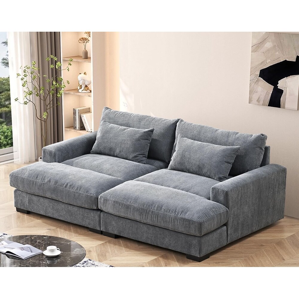 Convertible corduroy sleeper sofa with plush fabric and double chaise, offering comfort and style in a cozy setup.