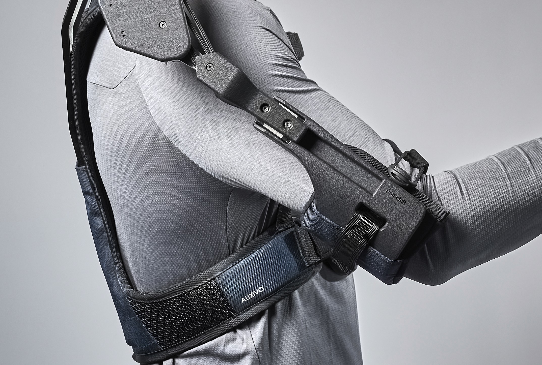 Close-up of the Auxivo DeltaSuit exoskeleton's mechanical arm fixed to the forearm, demonstrating the assistance system to support repetitive shoulder movements.