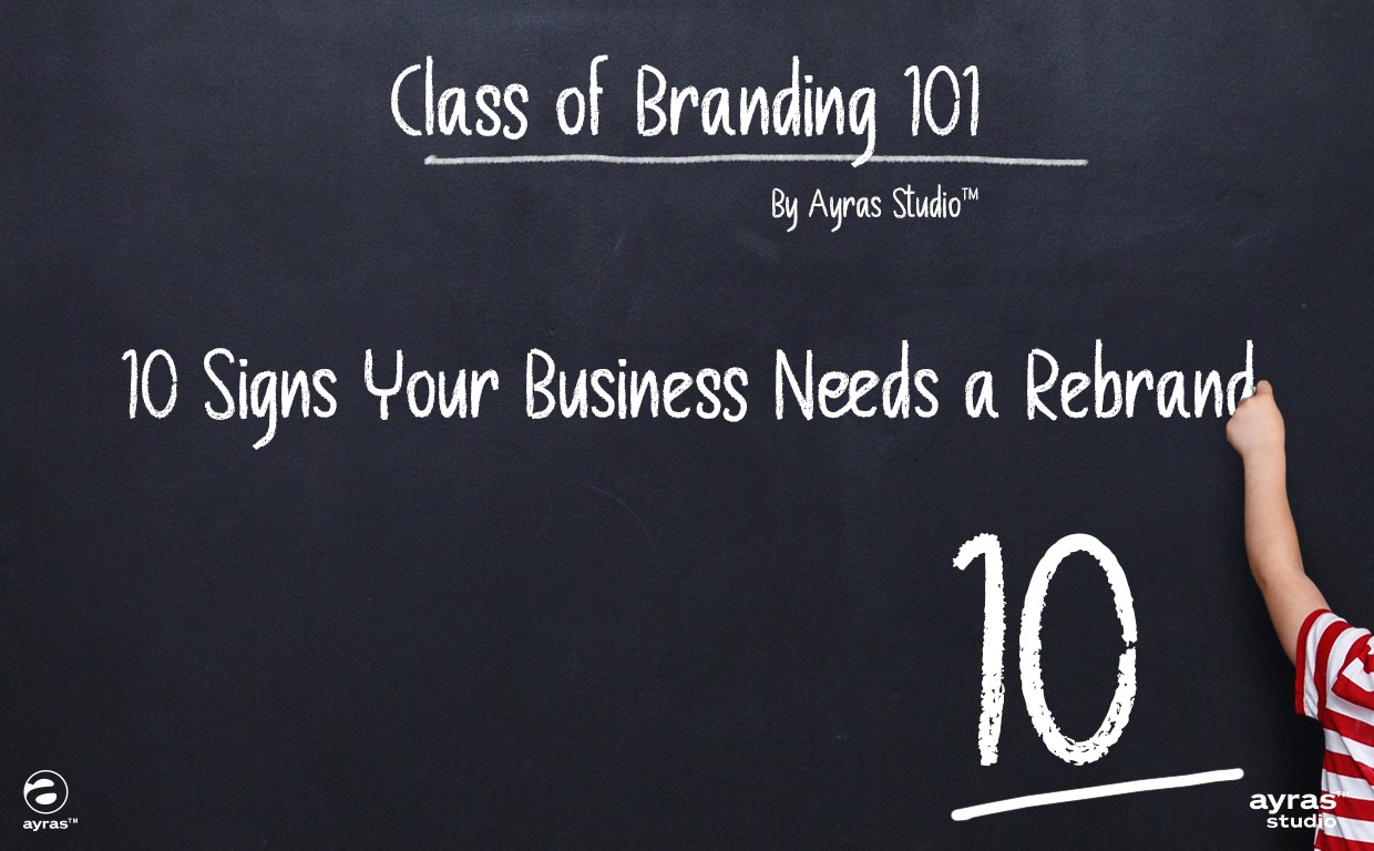 Business owner comparing old and new brand logos, realizing signs of outdated branding and the need for a professional rebrand