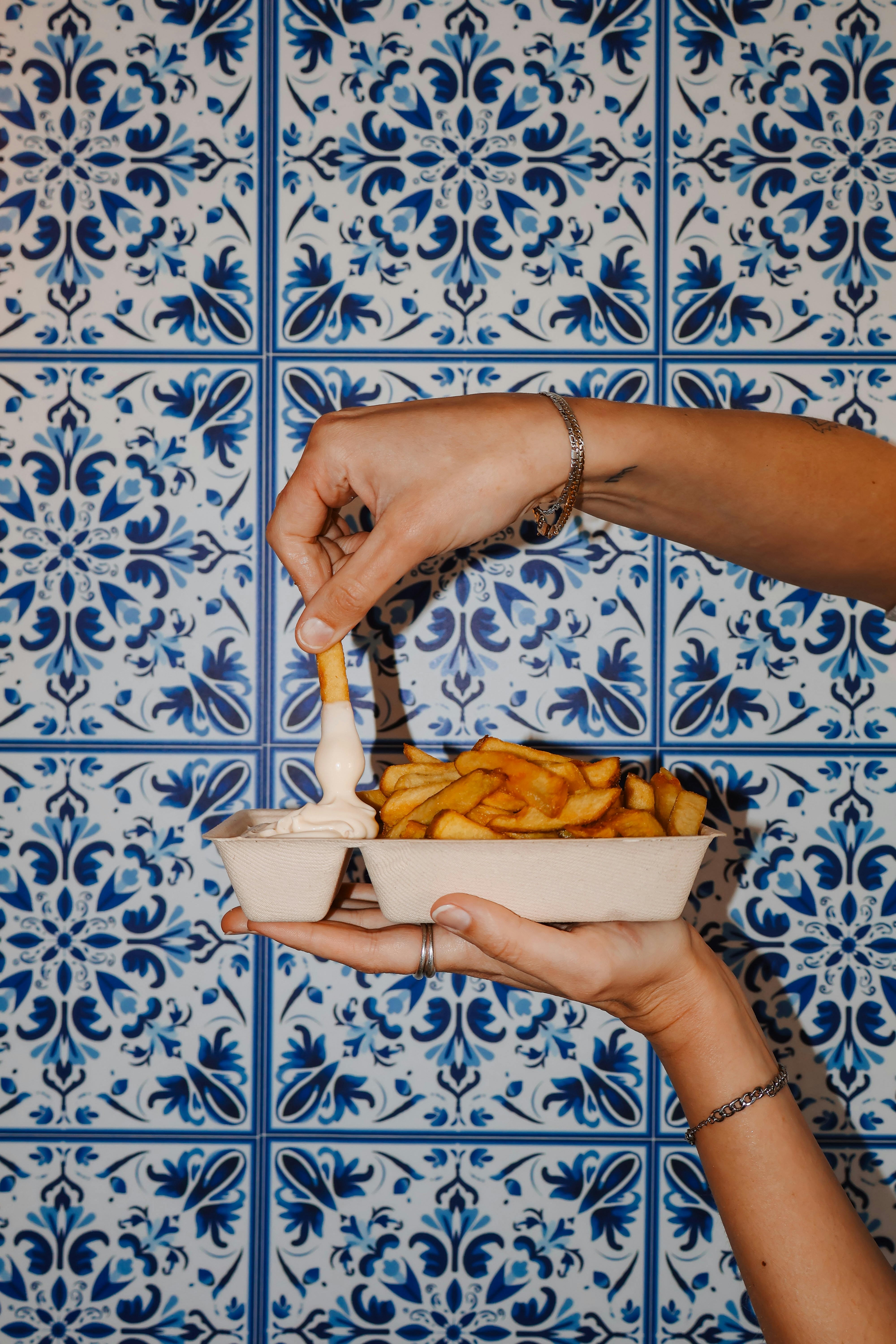 Dipping french fries into a creamy sauce