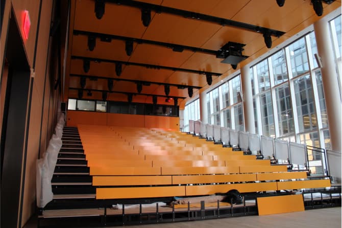 Stadium seating by a large window bathed in natural light