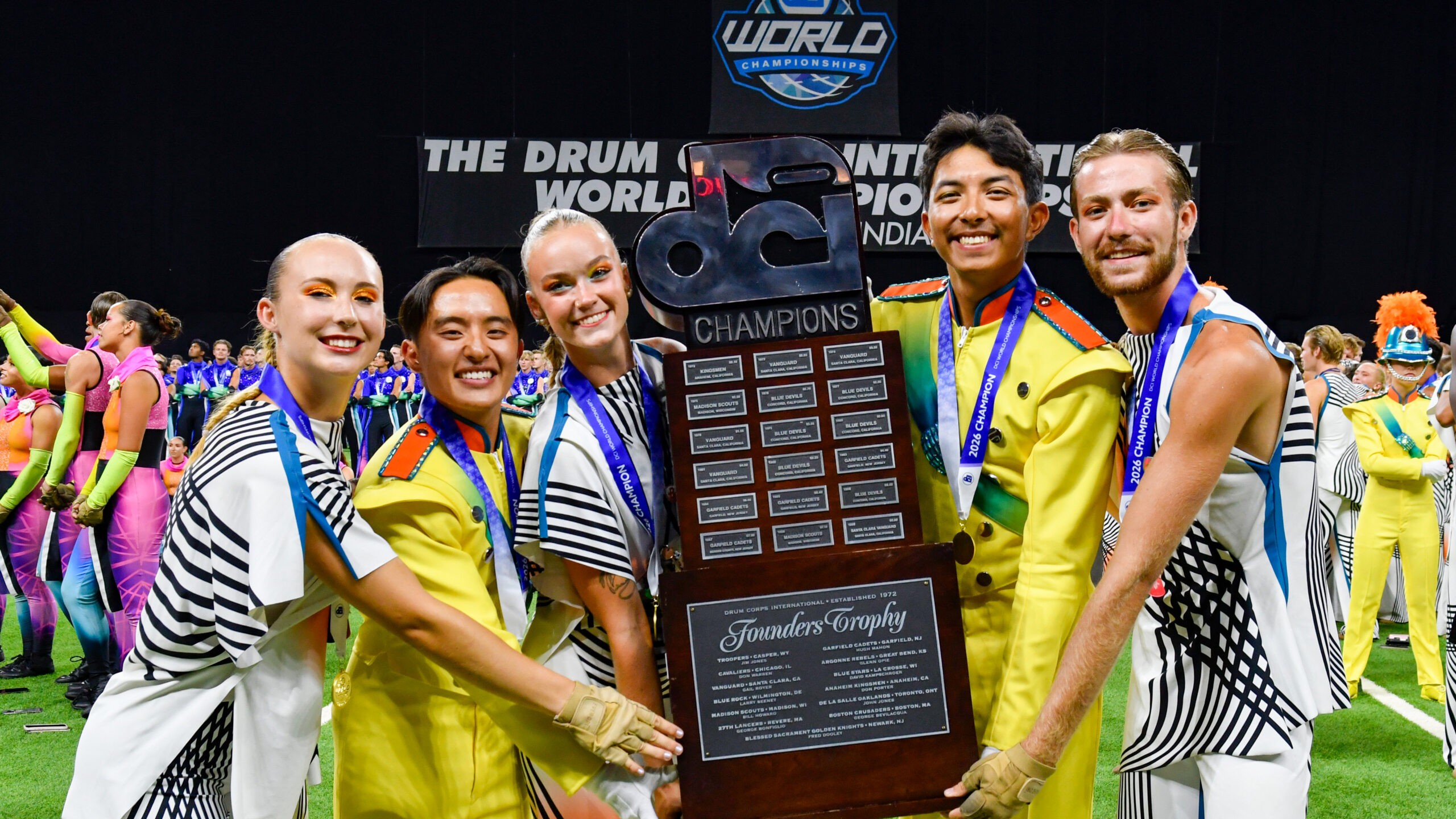 Bluecoats members celebrate their undefeated 2026 DCI championship season and third world title.