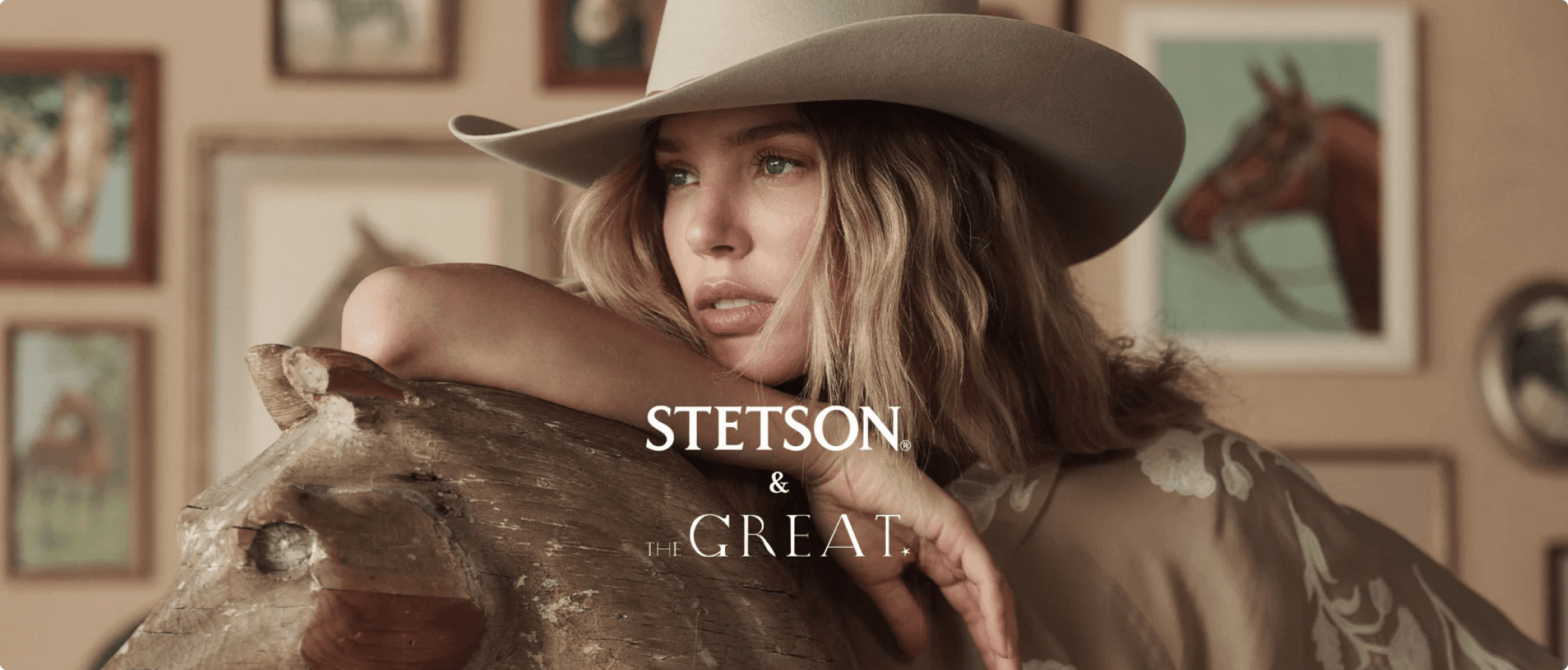 The GREAT. fashion campaign hero featuring model wearing Western hat and apparel