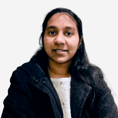 Headshot of employee, Shamini Dabare, on a blue tinted, grey background
