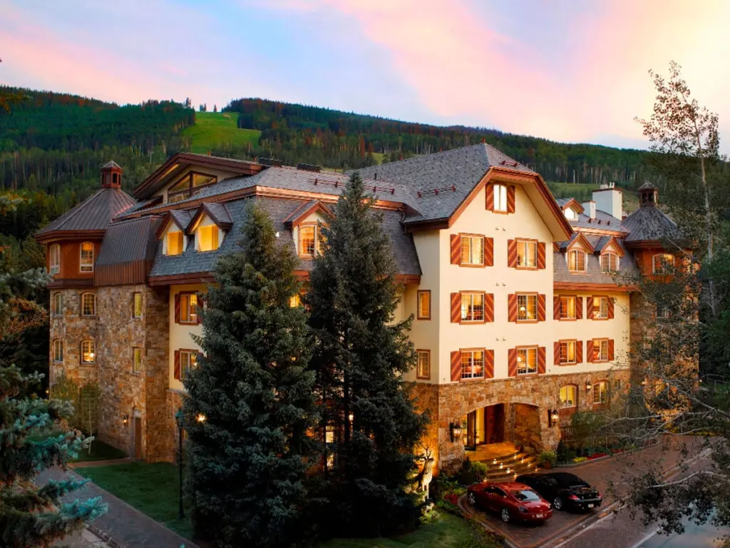 Charming mountain lodge wedding venue at Tivoli Lodge in Vail, Colorado, featuring alpine architecture, warm lighting, and scenic mountain views perfect for intimate weddings.