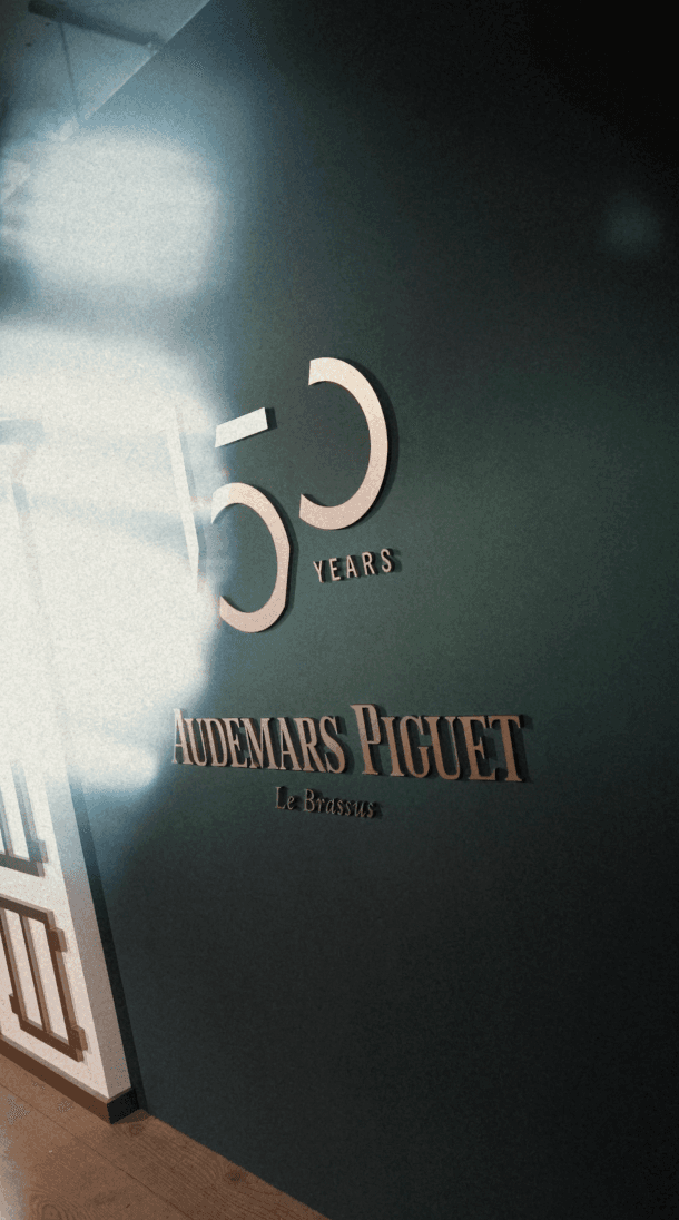 Tree branches against white house and fence