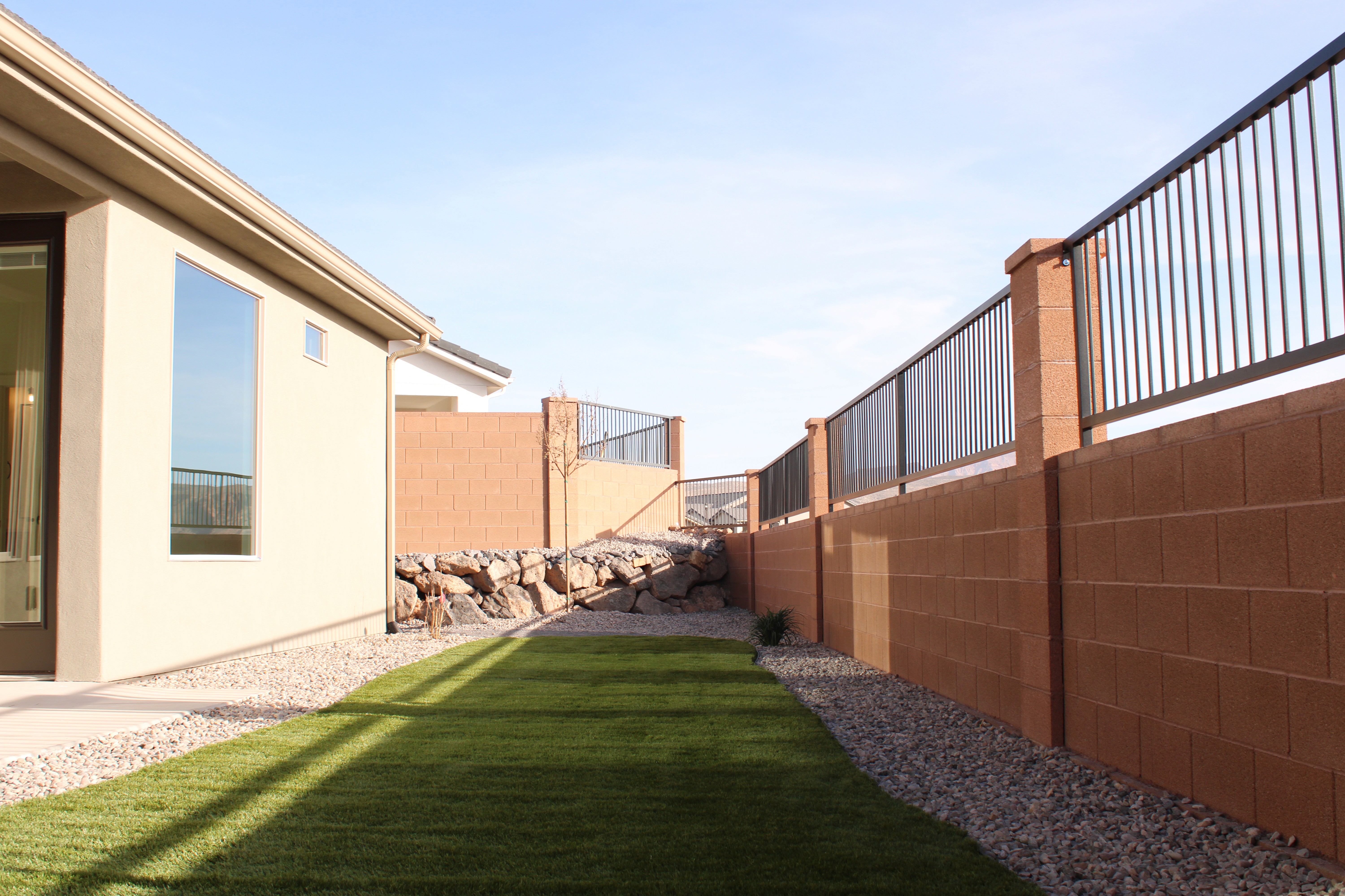 Outdoor living space behind the Golden Hour home in Hurricane, Utah with views of the backyard.