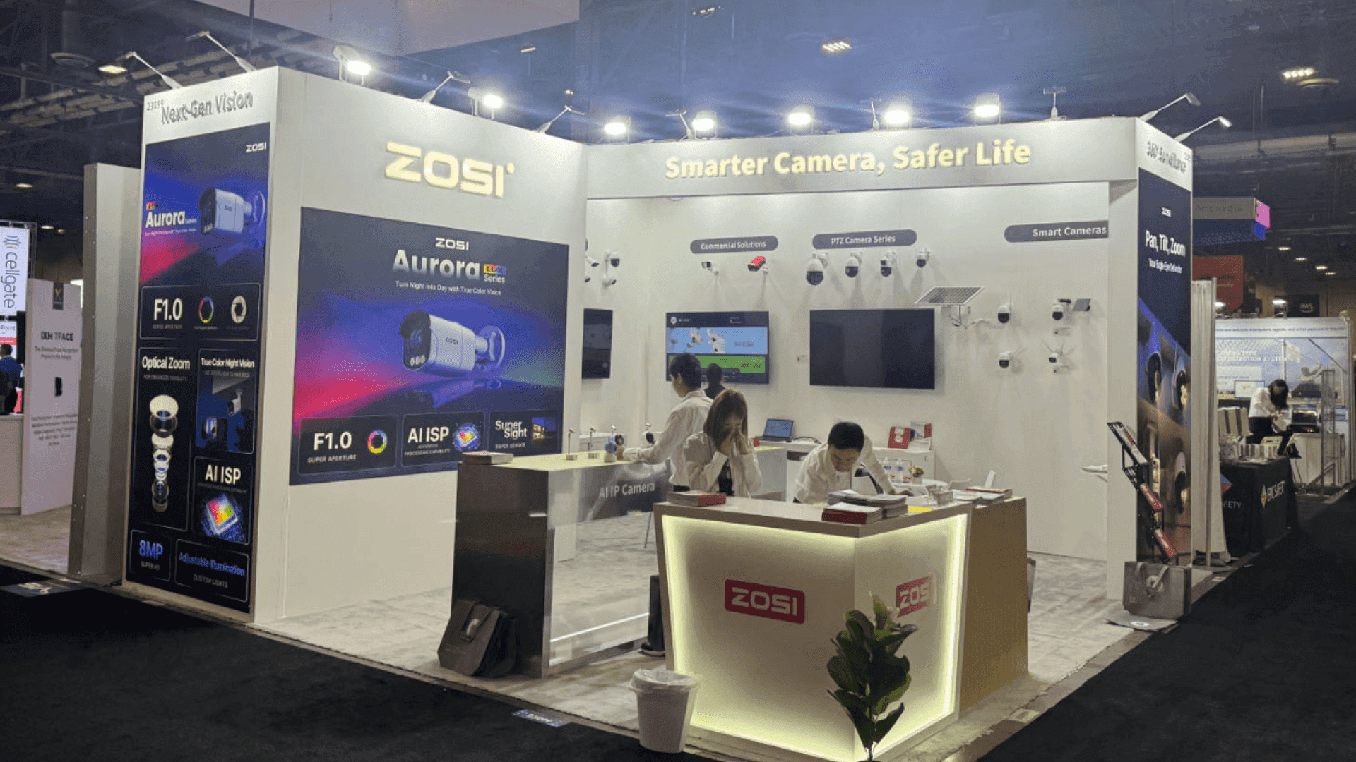 ZOSI ISC West 2024 20x20 security technology booth at The Venetian Expo with illuminated reception counter, brand wall, and smart camera product messaging