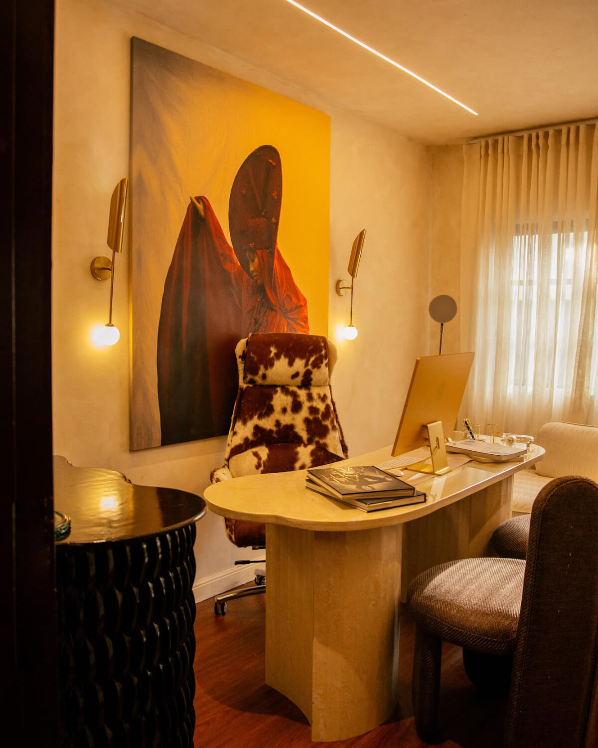 A room with a bed, a desk and a television