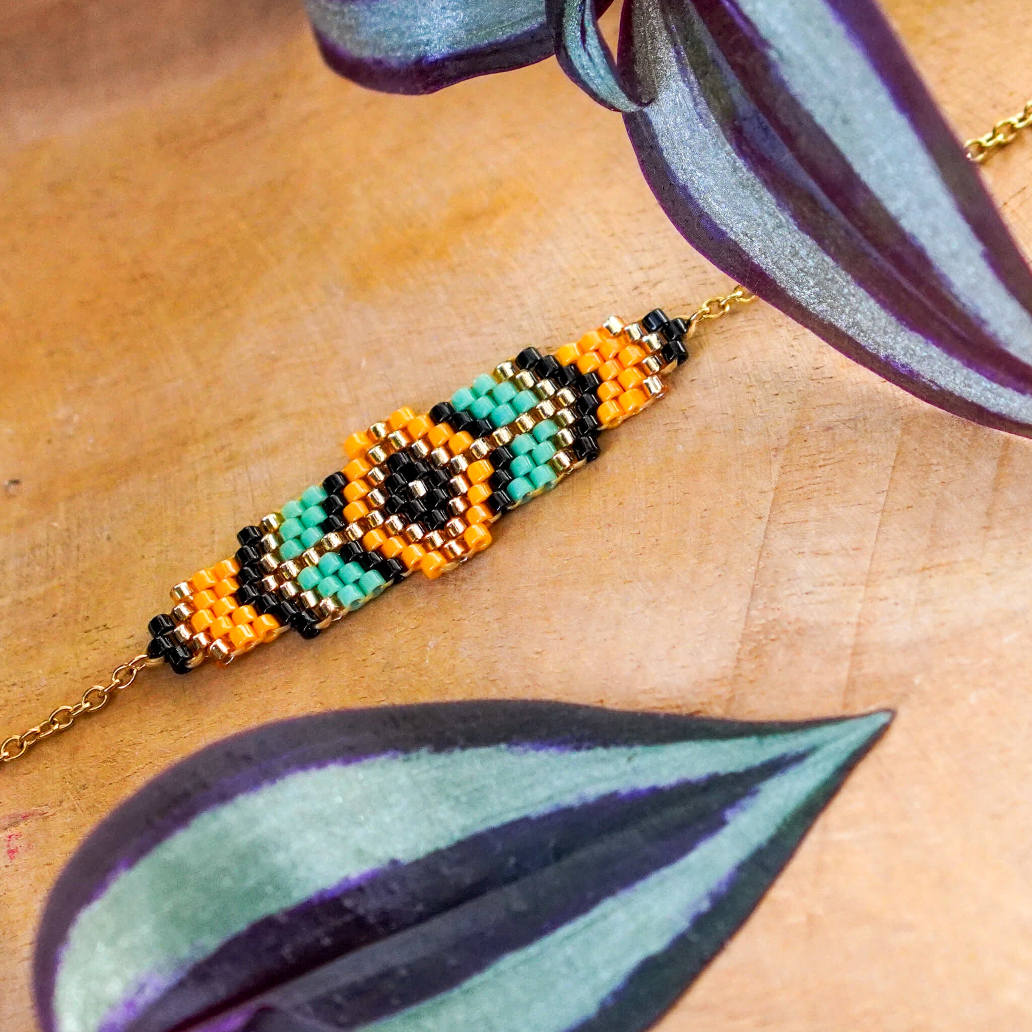 Migocząca bransoletka z koralików szklanych w kolorze morskim i pomarańczowym na łańcuszku ze stali