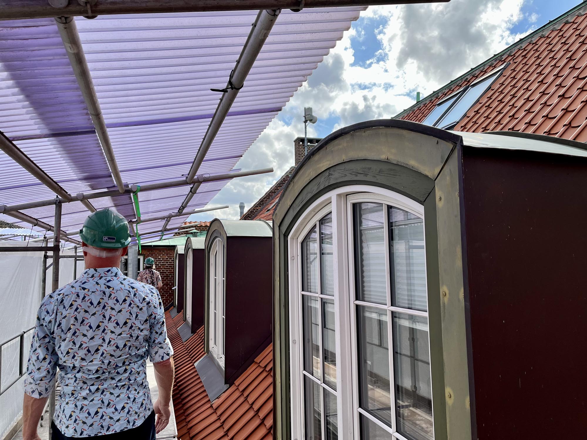 person on window looking at bicycles during daytime