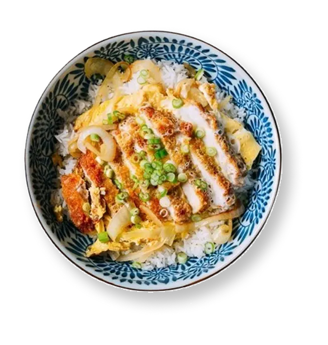 Overhead view of katsudon with sliced breaded cutlet, egg, and scallions over rice in a blue patterned bowl.