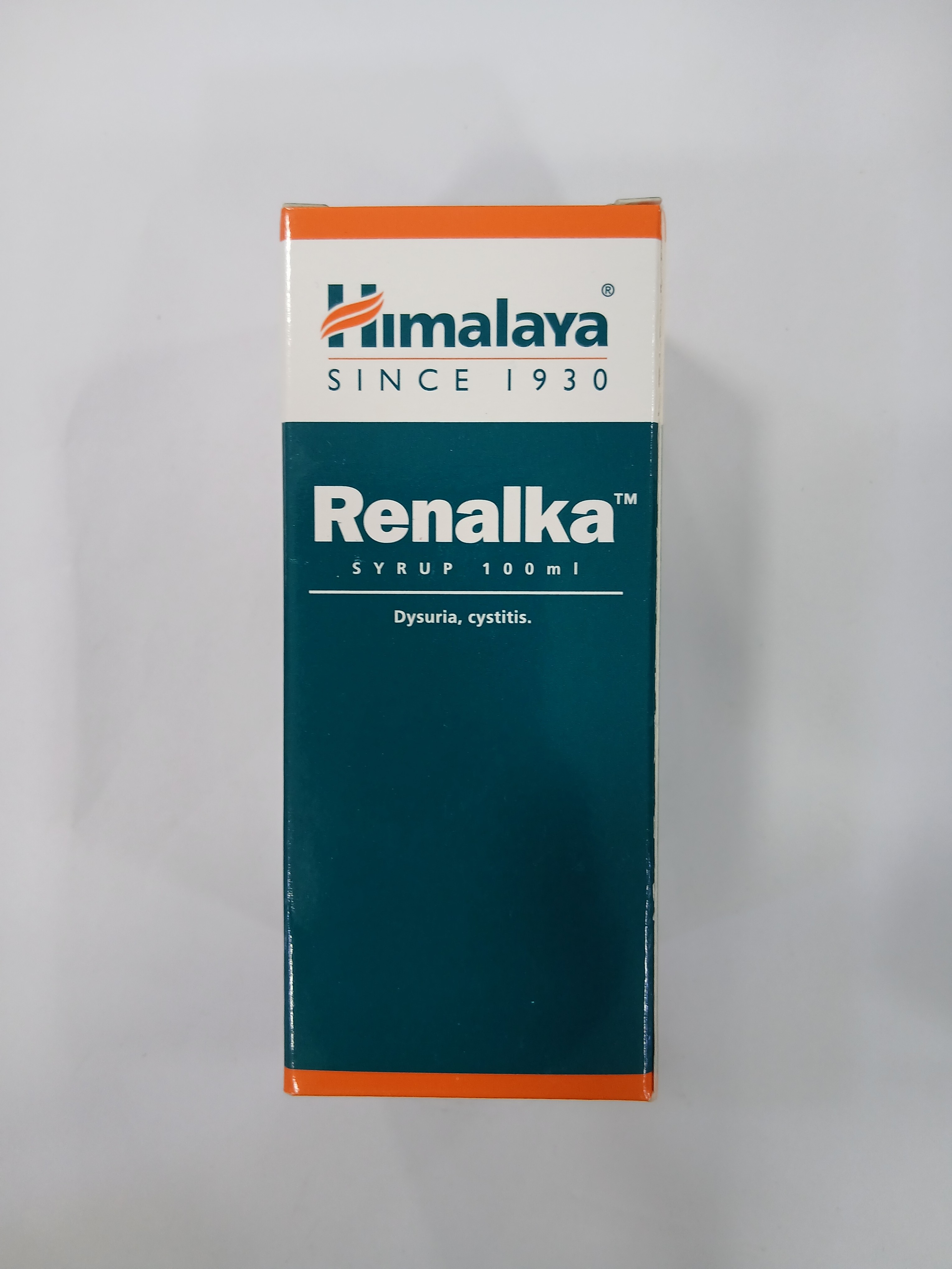 A tall, rectangular orange and dark teal cardboard syrup box displays white printed text including the brand name Himalaya, the product name, dosage information, and usage details for conditions like dysuria and cystitis.