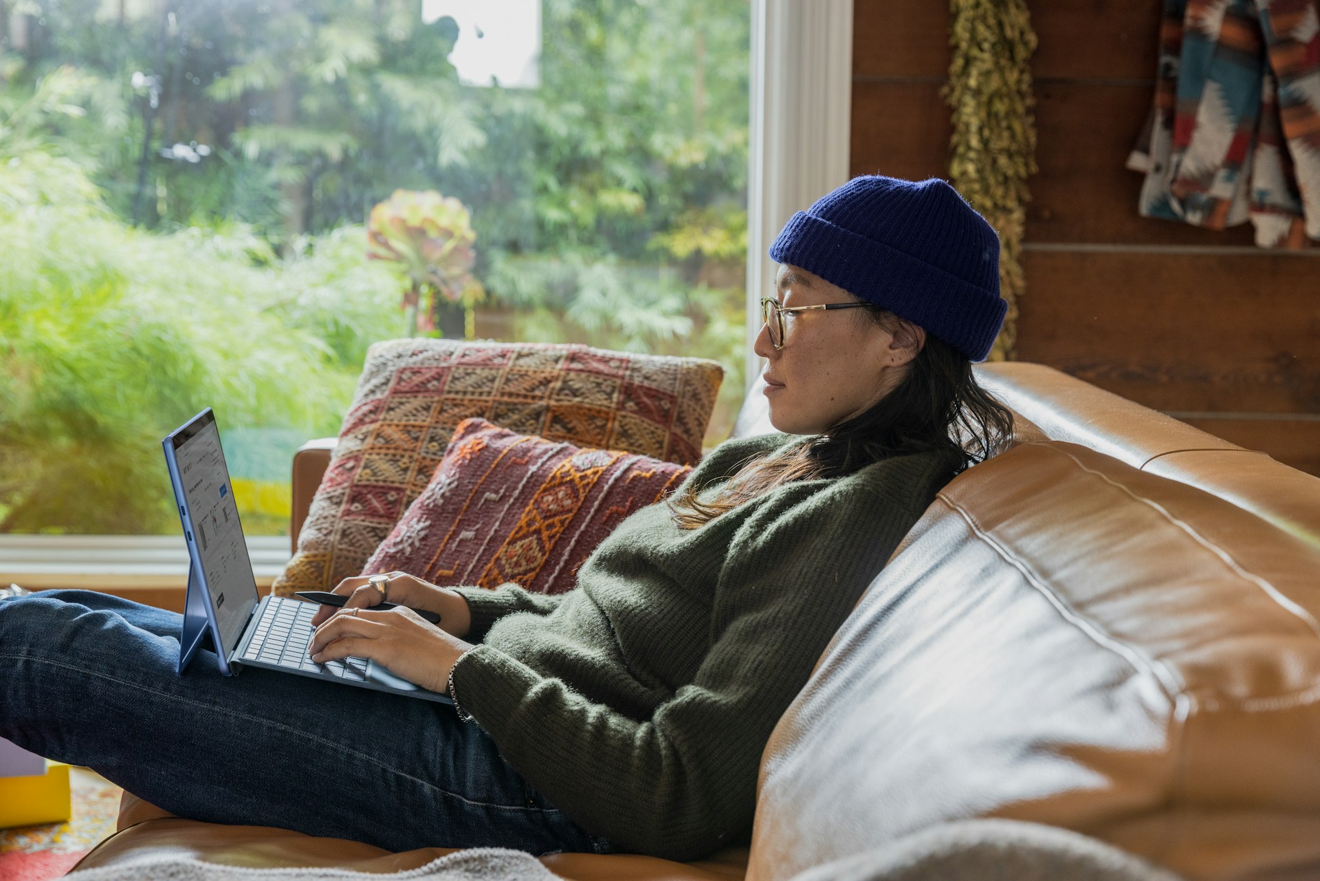 a woman sitting behind a laptop typing