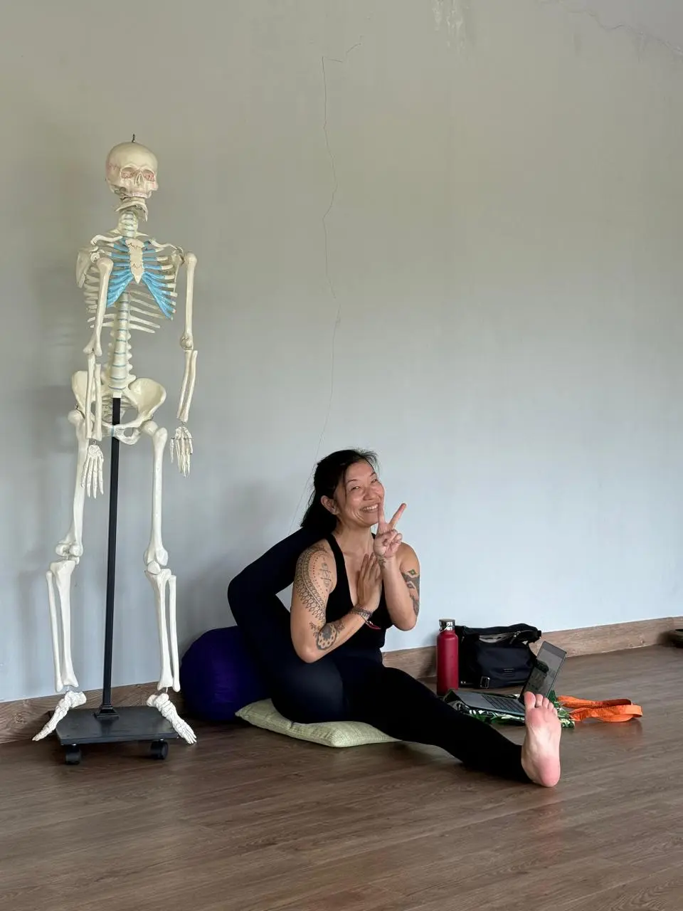 Vivienne Zeng riding a yellow scooter in Bali, enjoying the tropical lifestyle during yoga teacher training downtime.