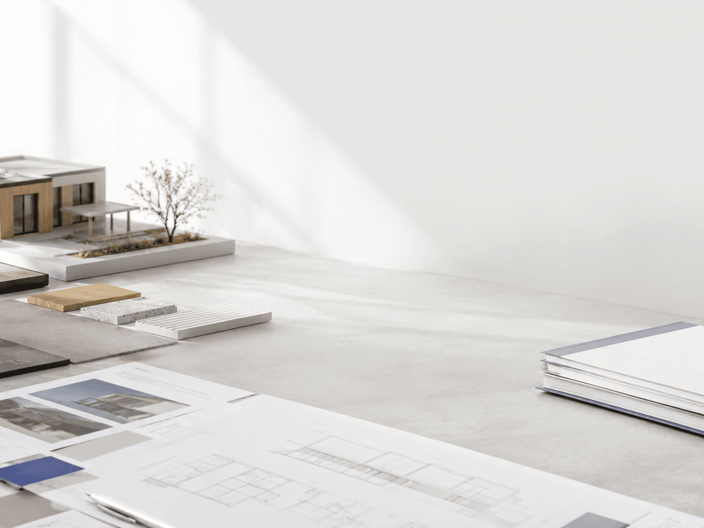 Minimalist architectural workspace with neatly arranged material samples, design documents, and a clean neutral setting, softly lit to create a calm background for downloadable building resources.