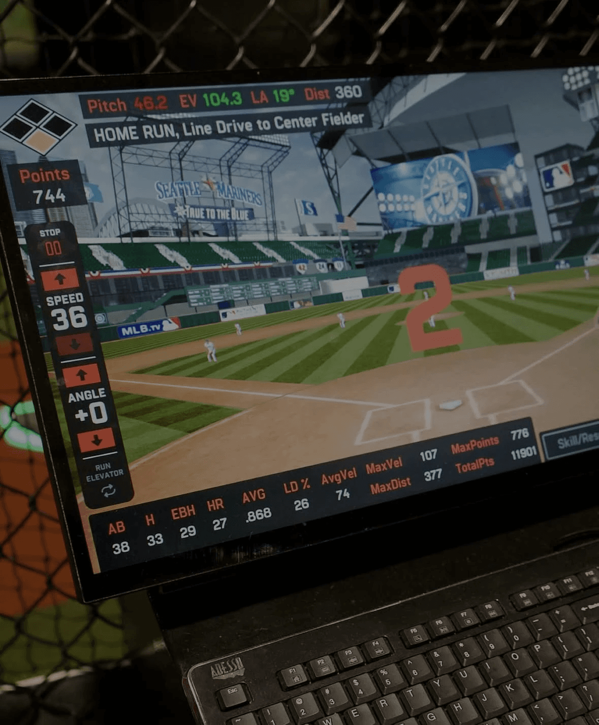 Close-up of a HitTrax game display showing a virtual MLB ballpark and hit metrics.