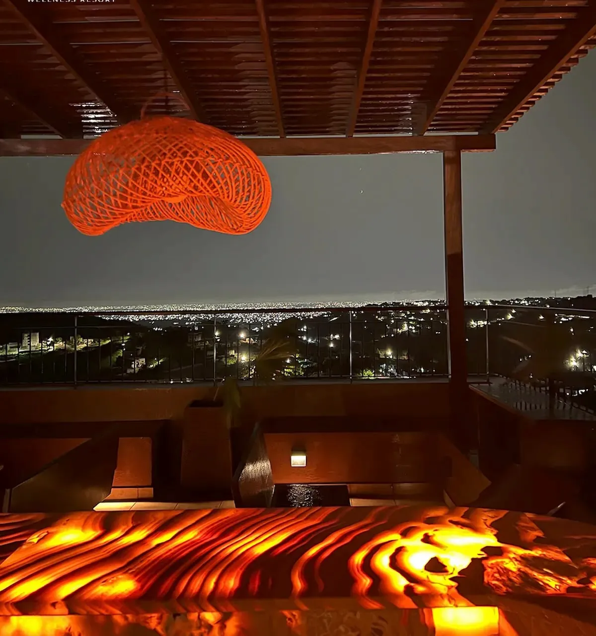 A stunning rooftop view of Accra at night showcasing the city's lights.