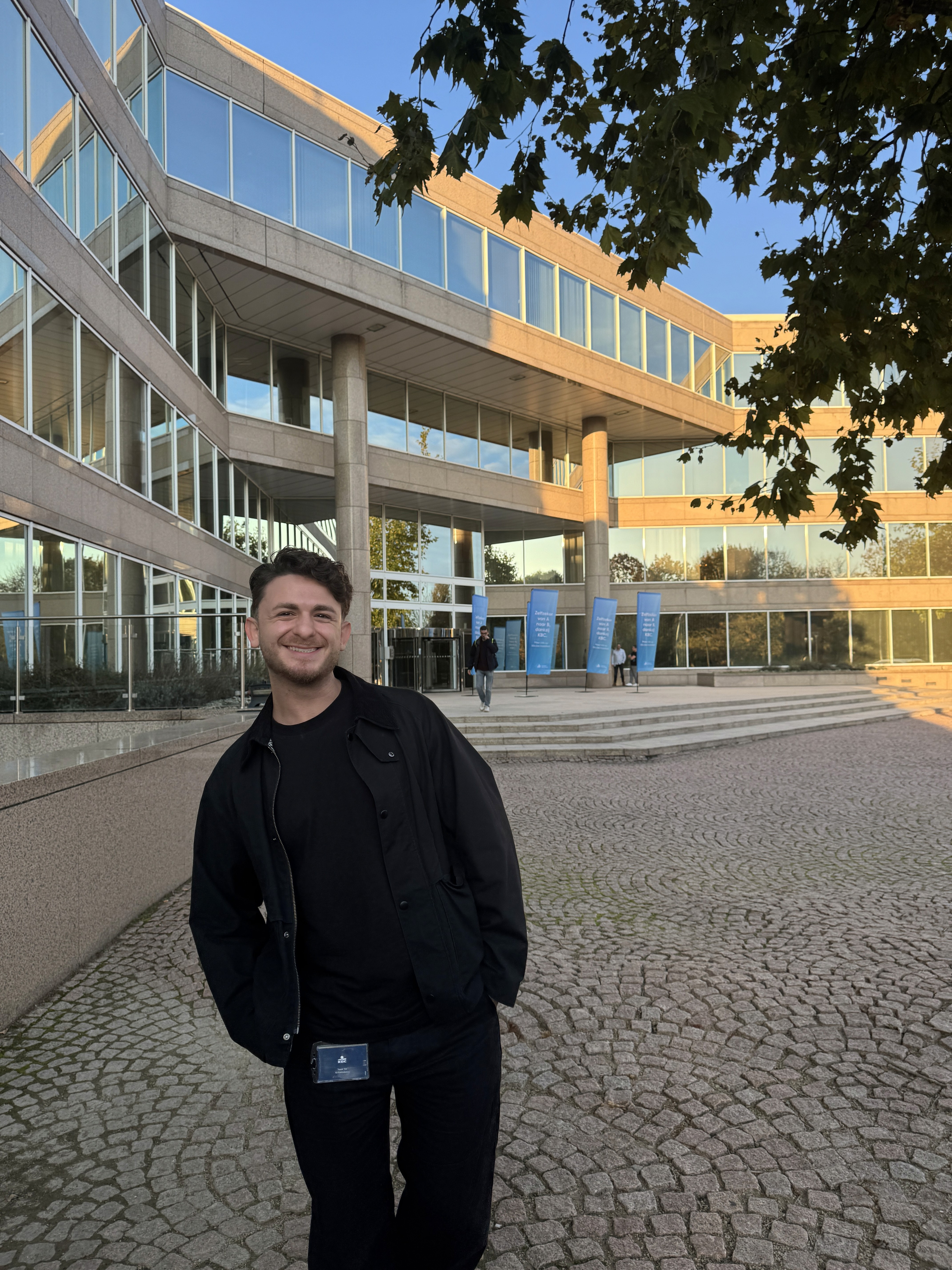 Group of friends smiling on a lively city street at night