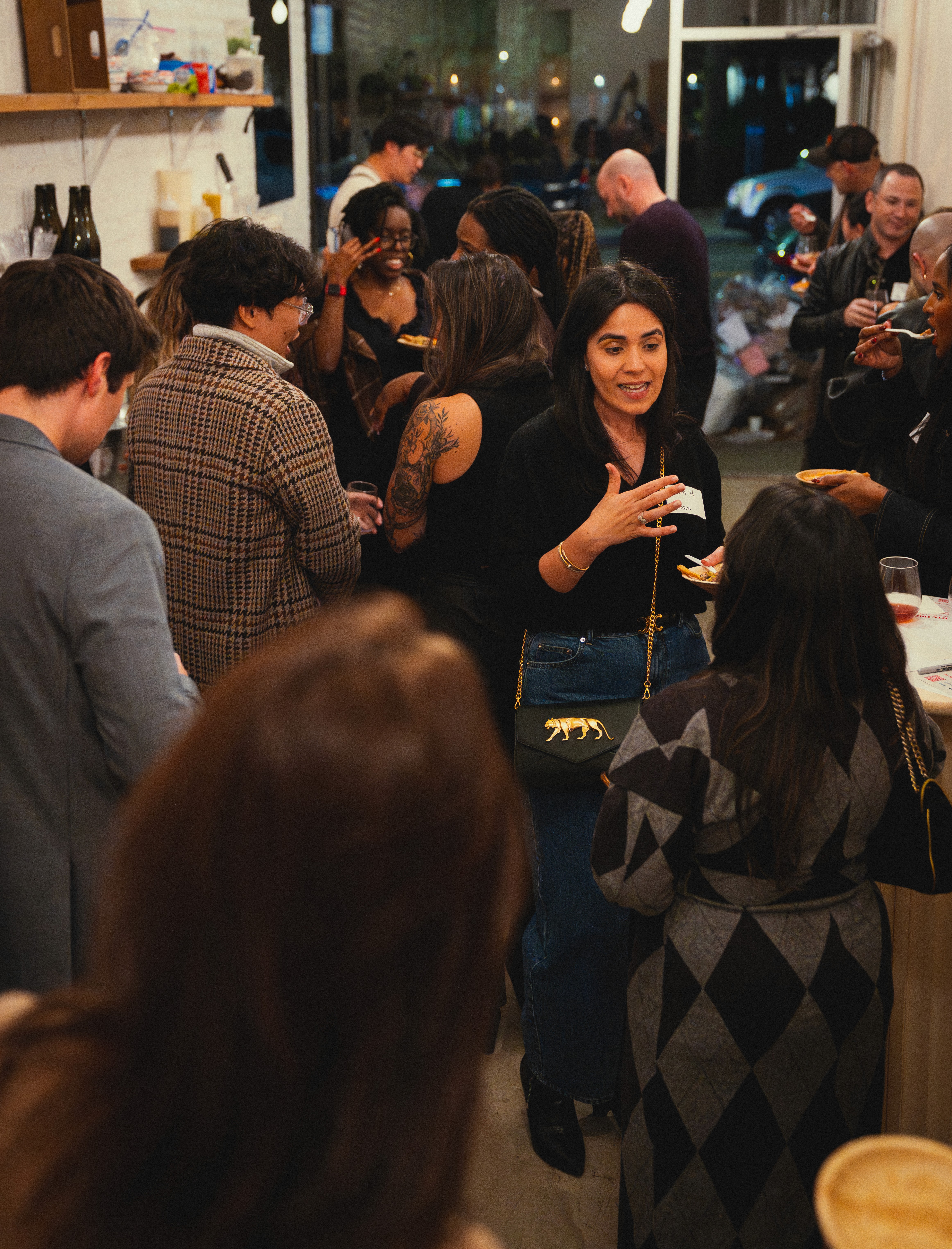People at a wine event chatting and drinking wine.